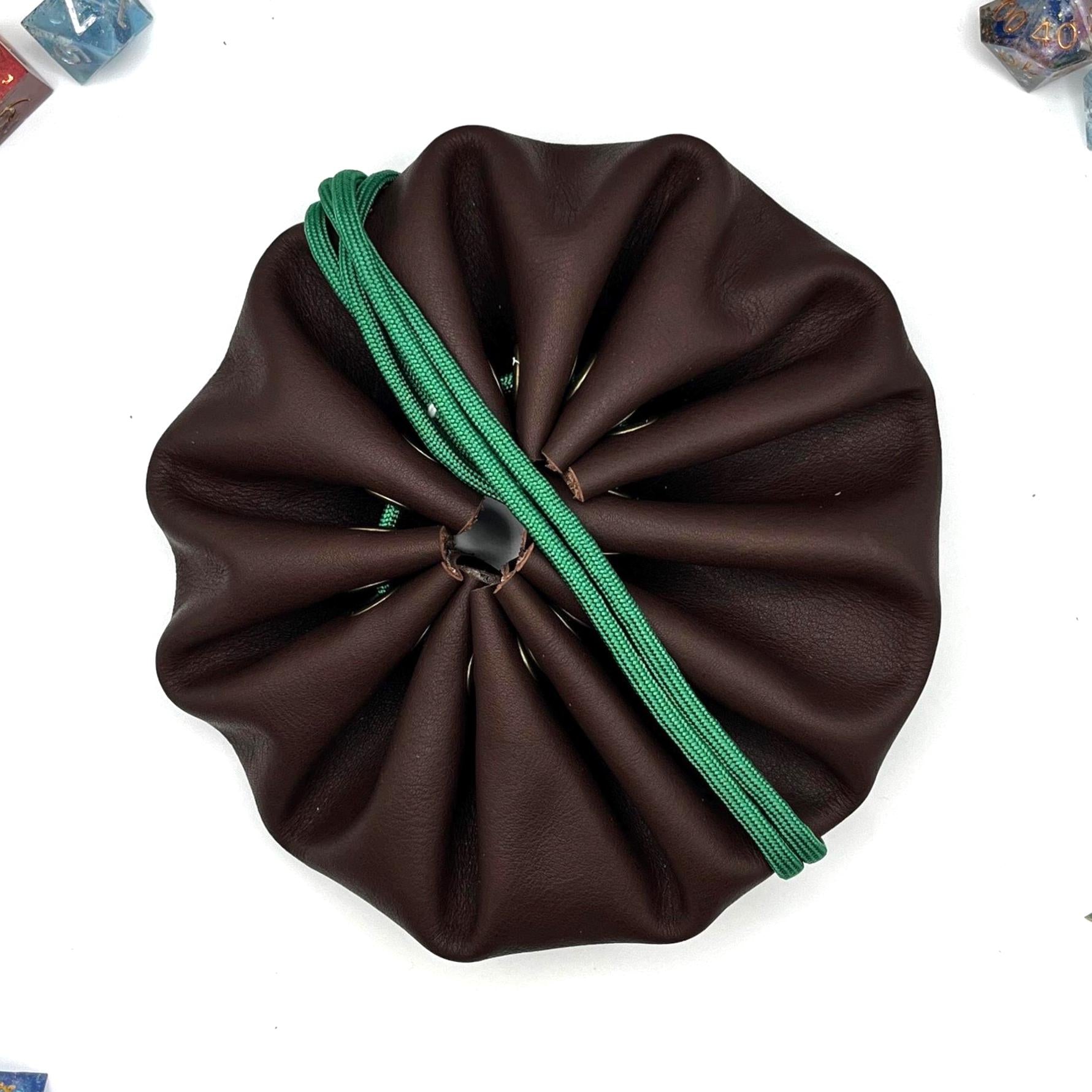 Handcrafted leather dice bag with drawstring, ideal for storing RPG dice sets. Perfect for DnD, tabletop games, or as a fantasy gift for gamers.