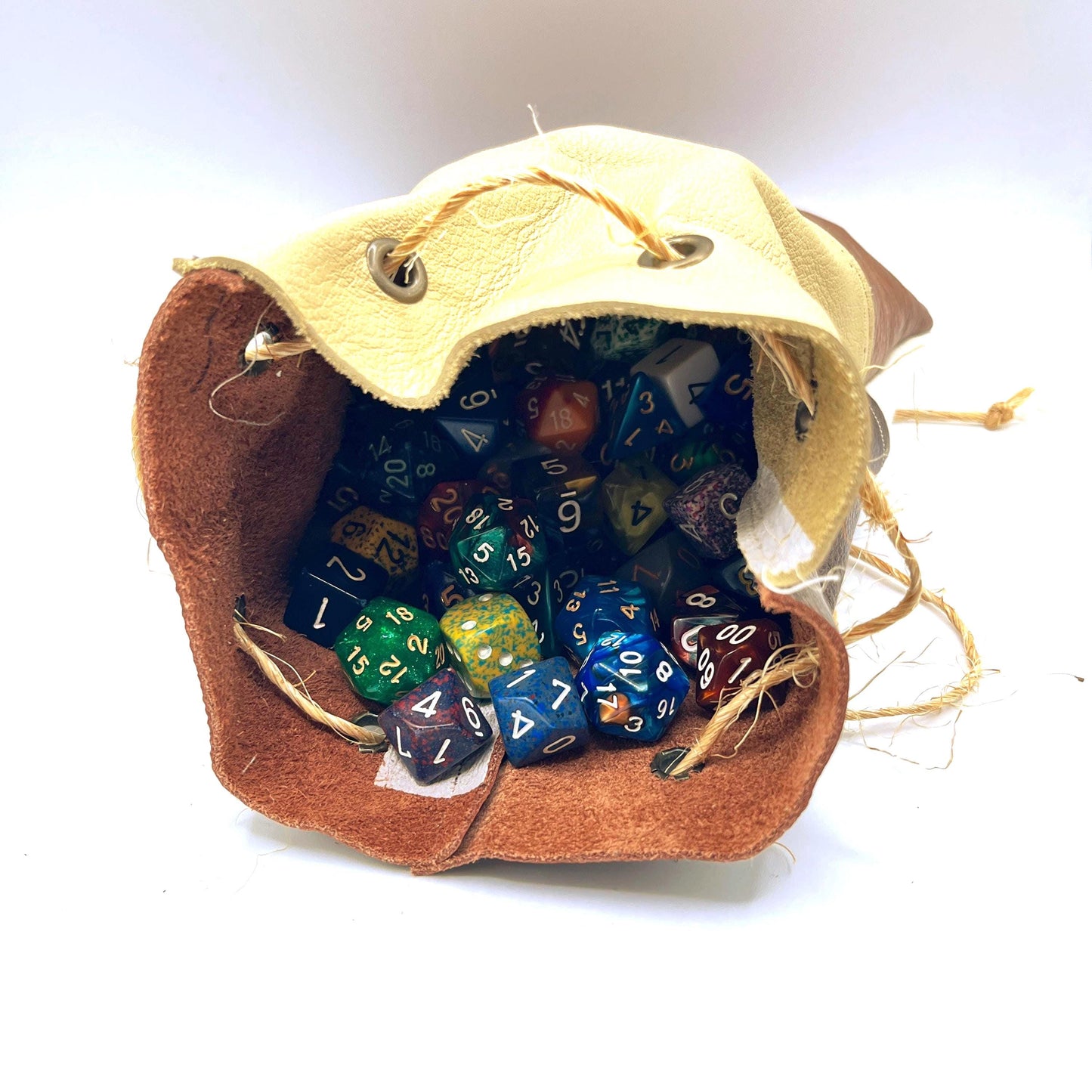 Handcrafted leather dice bag with drawstring, ideal for storing RPG dice sets. Perfect for DnD, tabletop games, or as a fantasy gift for gamers.