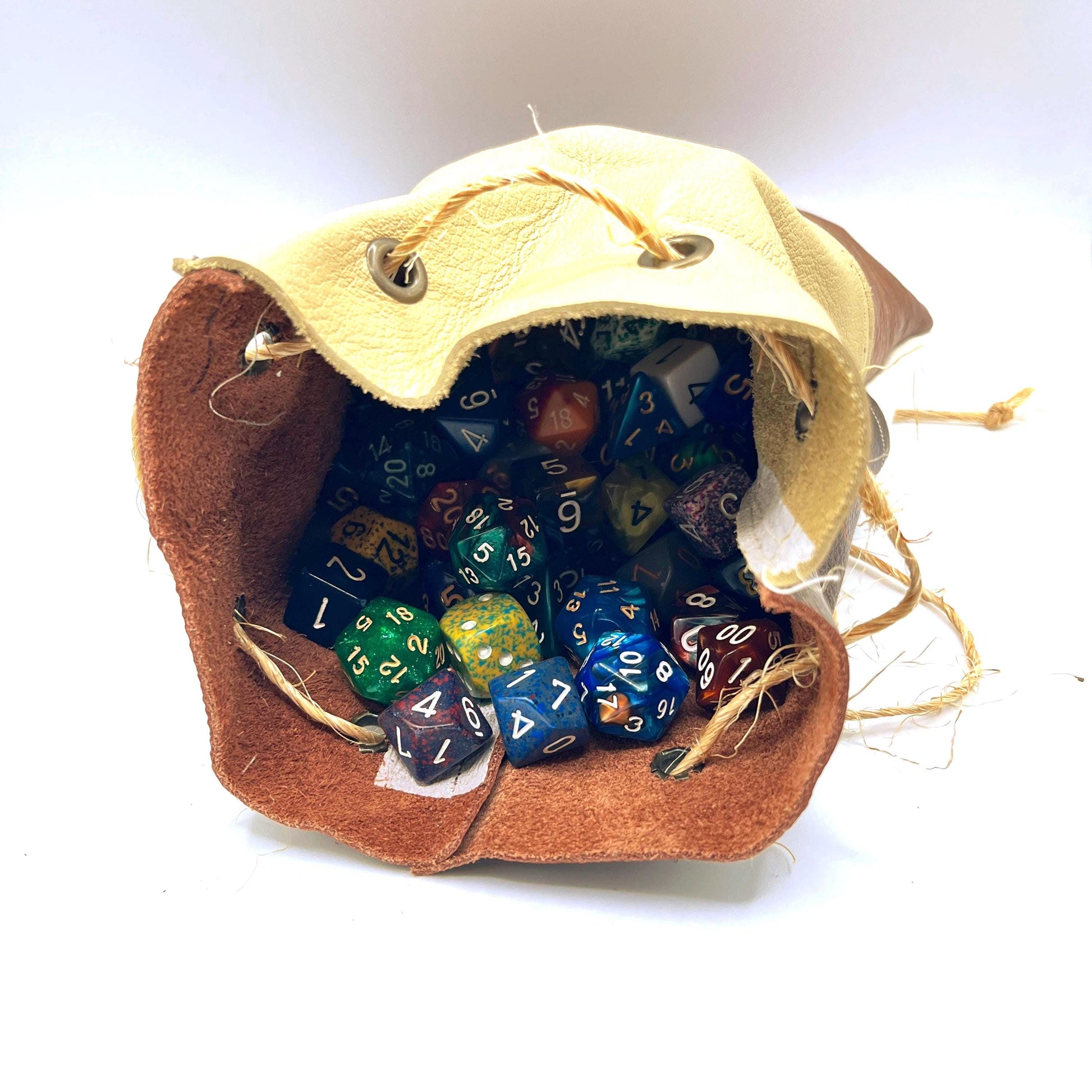 Handcrafted leather dice bag with drawstring, ideal for storing RPG dice sets. Perfect for DnD, tabletop games, or as a fantasy gift for gamers.