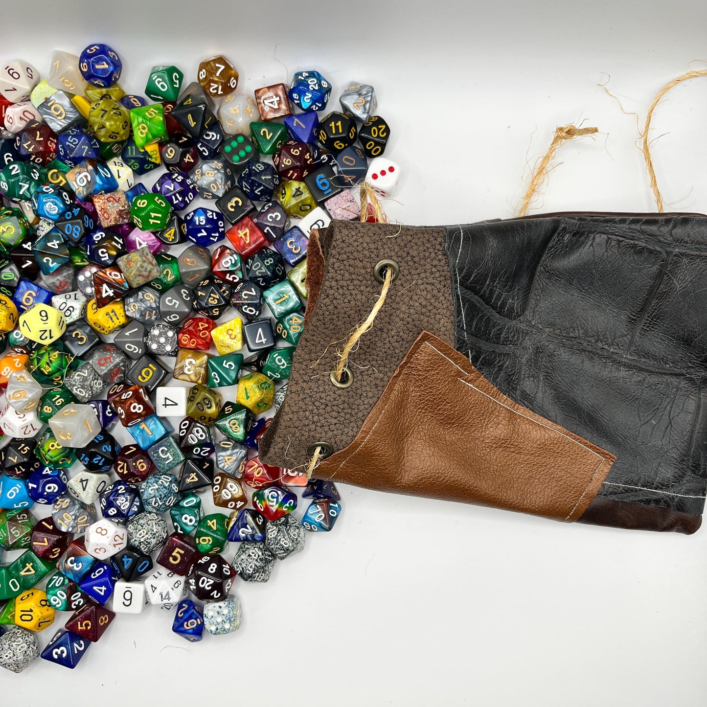 Handcrafted leather dice bag with drawstring, ideal for storing RPG dice sets. Perfect for DnD, tabletop games, or as a fantasy gift for gamers.
