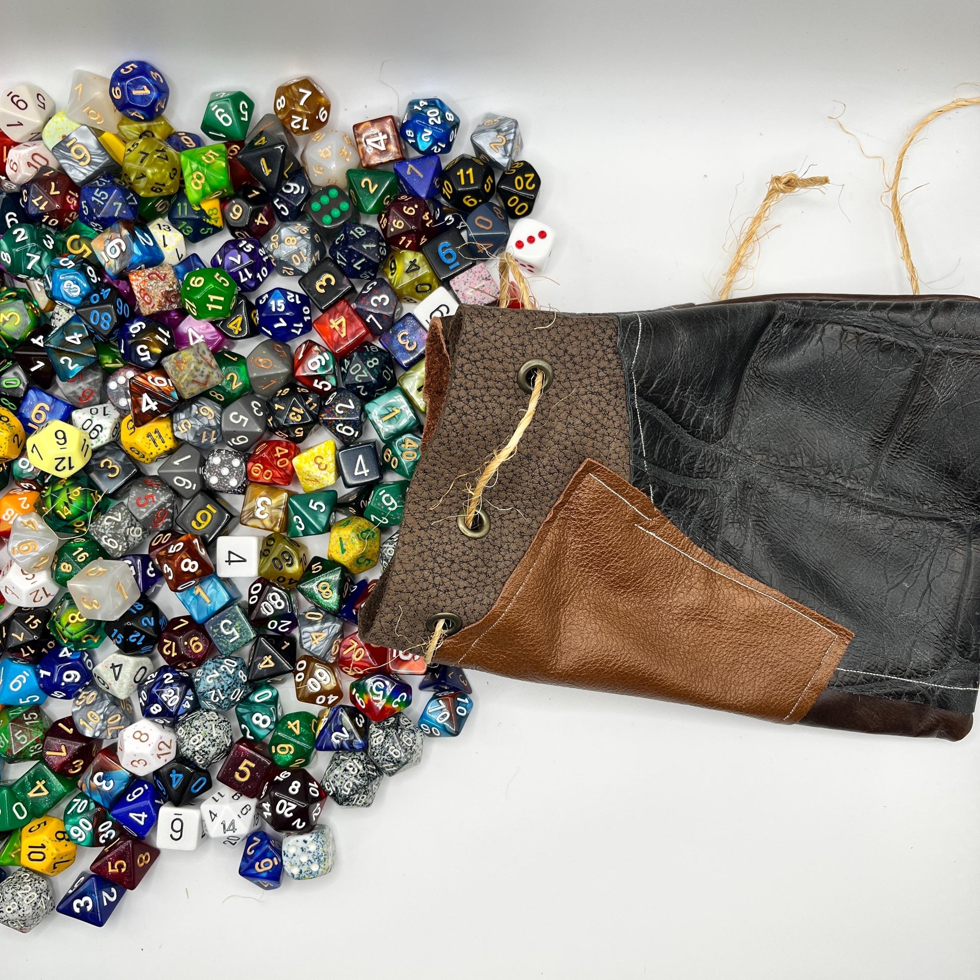 Handcrafted leather dice bag with drawstring, ideal for storing RPG dice sets. Perfect for DnD, tabletop games, or as a fantasy gift for gamers.