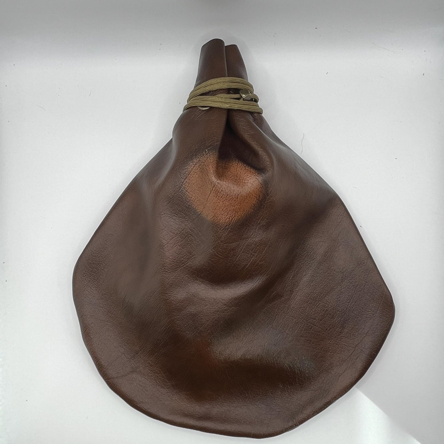 Handcrafted leather dice bag with drawstring, ideal for storing RPG dice sets. Perfect for DnD, tabletop games, or as a fantasy gift for gamers.