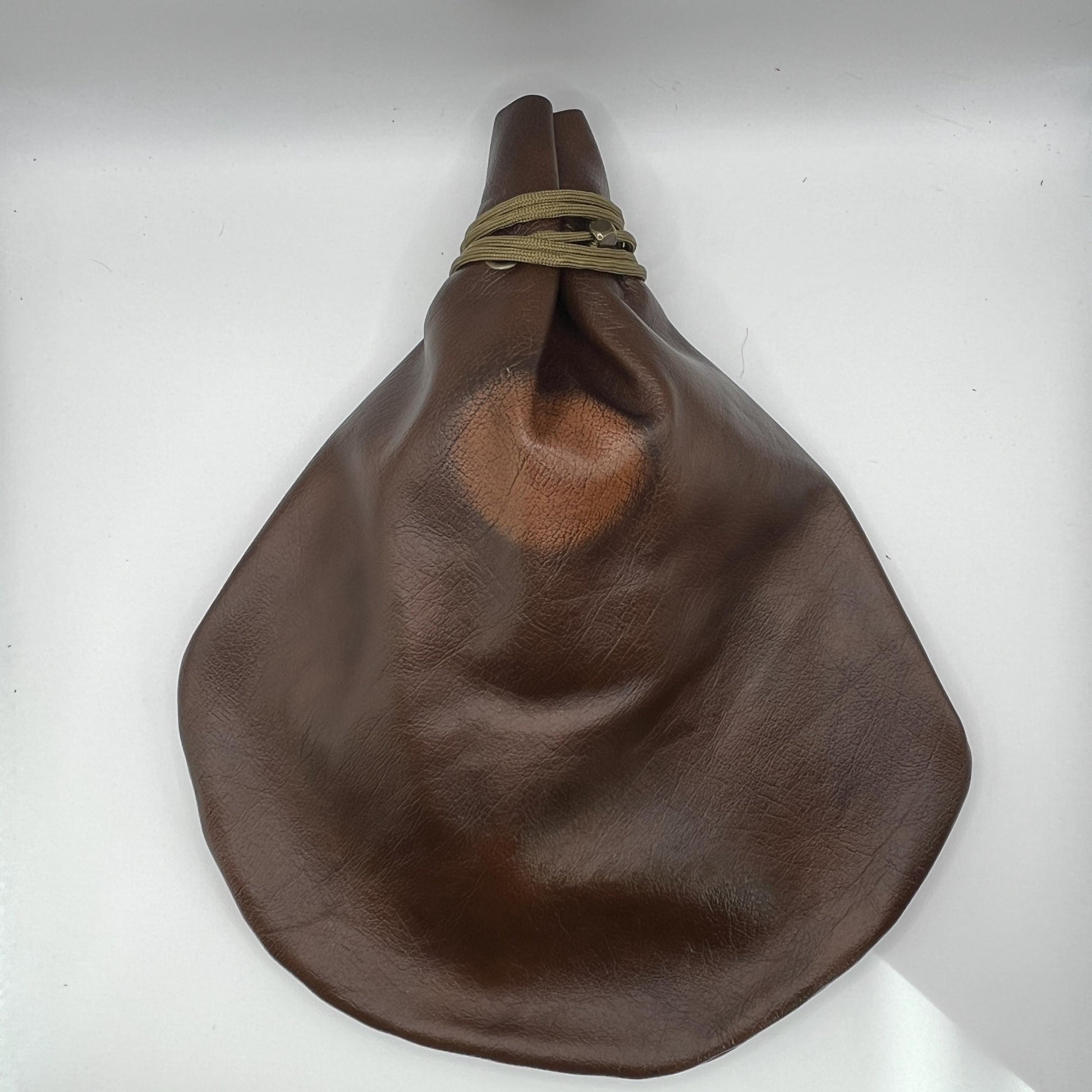 Handcrafted leather dice bag with drawstring, ideal for storing RPG dice sets. Perfect for DnD, tabletop games, or as a fantasy gift for gamers.