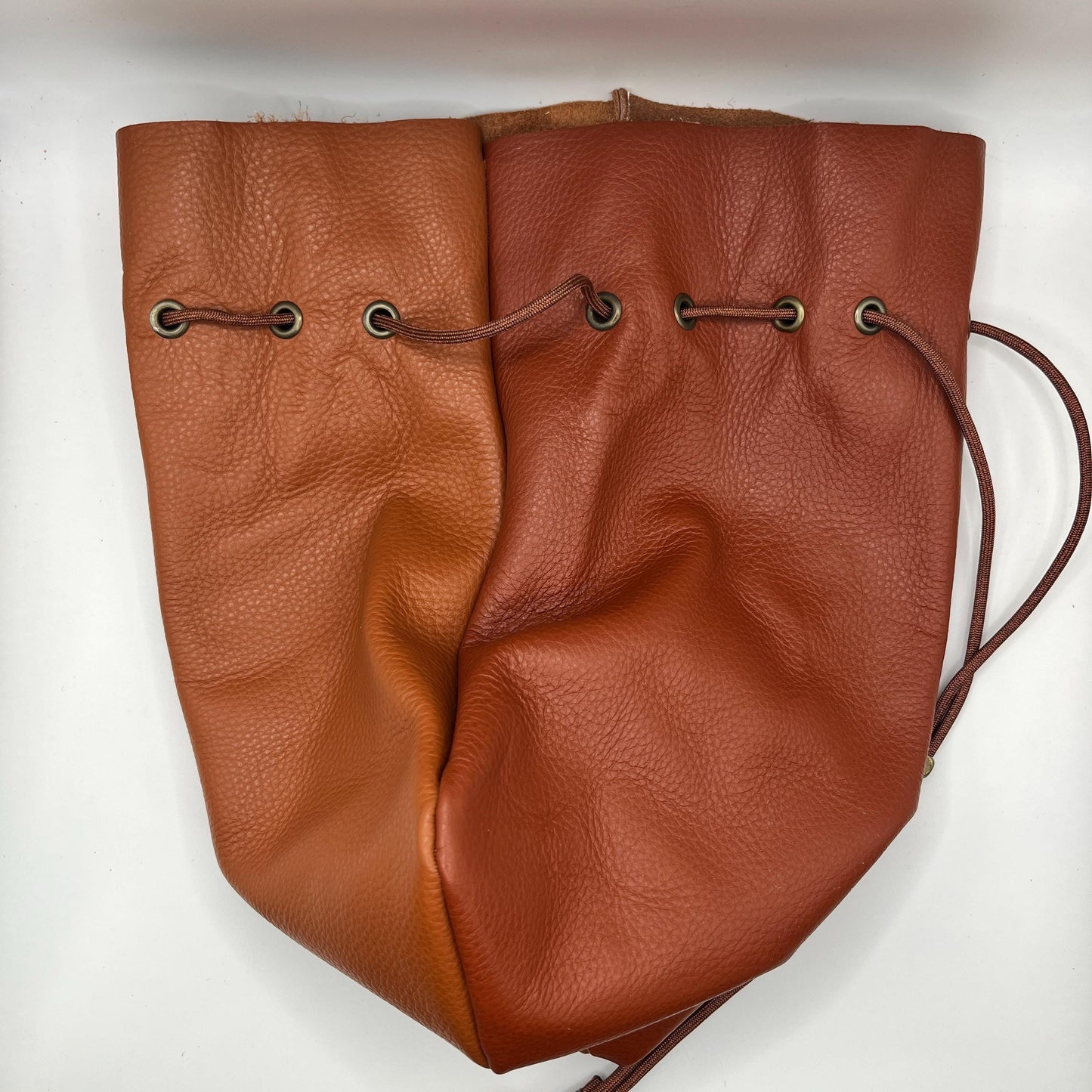 Handcrafted leather dice bag with drawstring, ideal for storing RPG dice sets. Perfect for DnD, tabletop games, or as a fantasy gift for gamers.