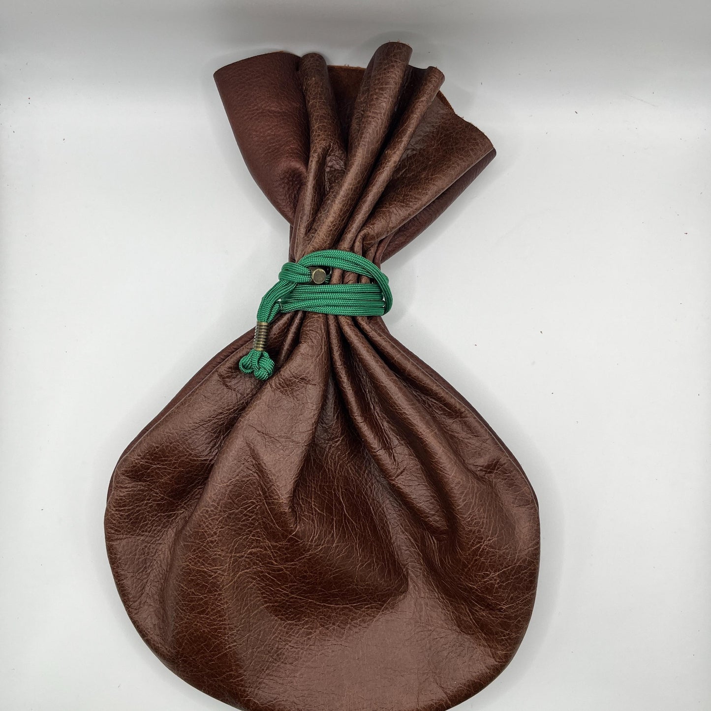 Handcrafted leather dice bag with drawstring, ideal for storing RPG dice sets. Perfect for DnD, tabletop games, or as a fantasy gift for gamers.