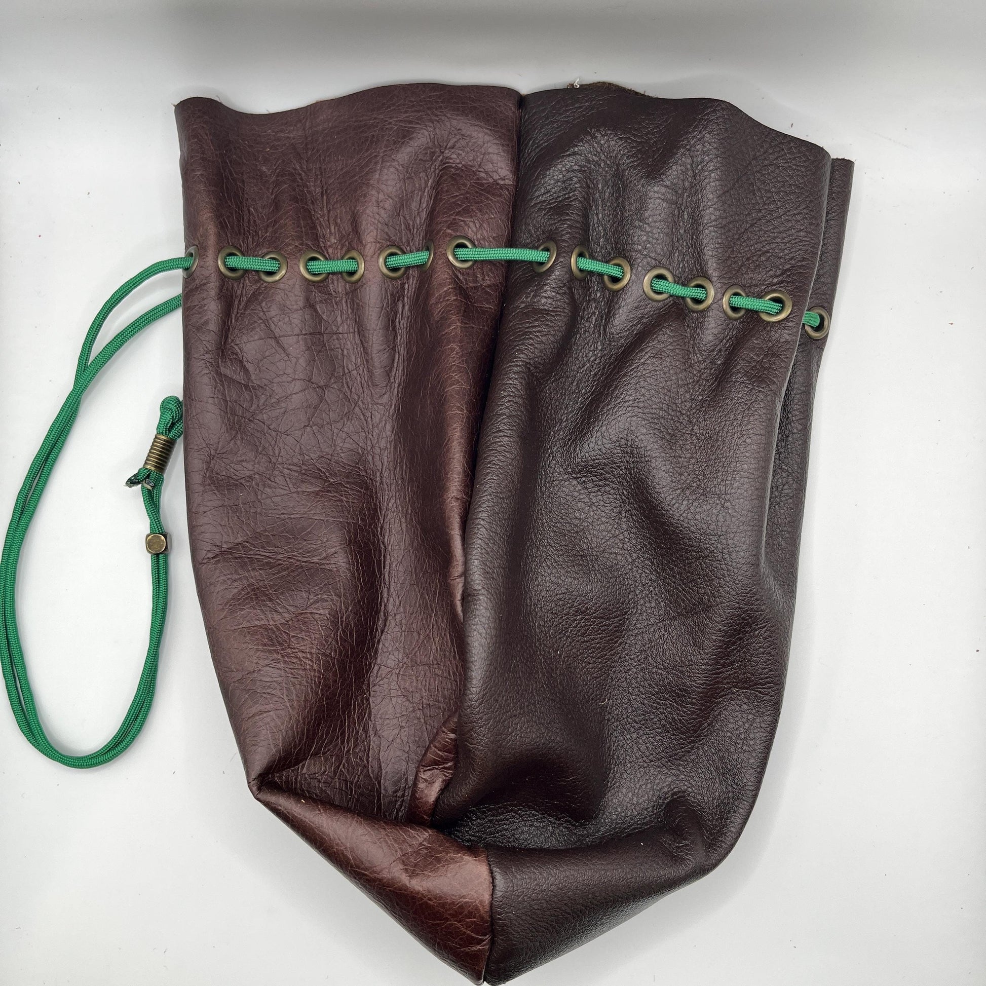 Handcrafted leather dice bag with drawstring, ideal for storing RPG dice sets. Perfect for DnD, tabletop games, or as a fantasy gift for gamers.