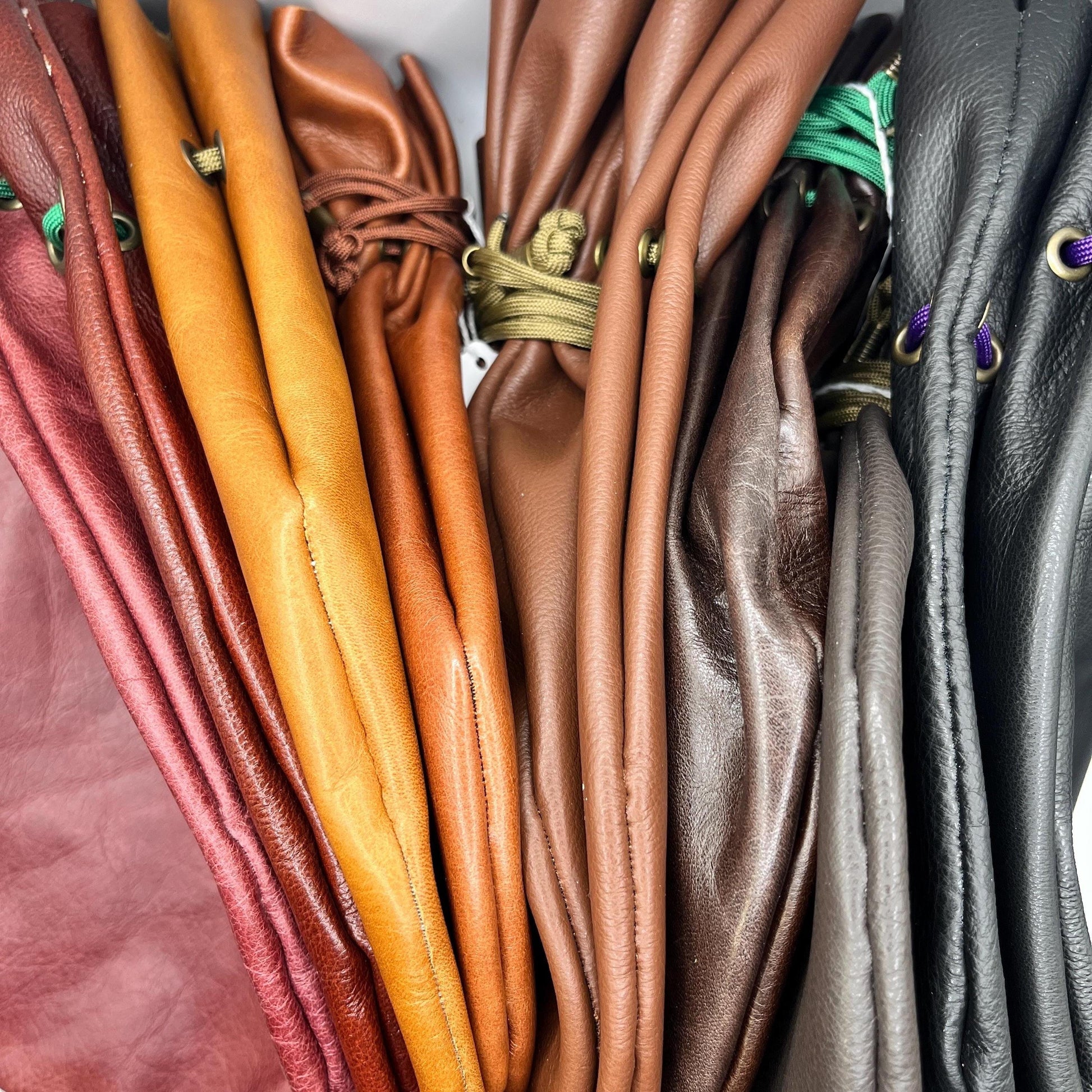 Handcrafted leather dice bag with drawstring, ideal for storing RPG dice sets. Perfect for DnD, tabletop games, or as a fantasy gift for gamers.