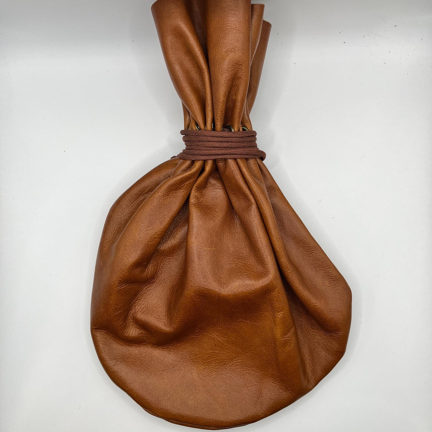 Handcrafted leather dice bag with drawstring, ideal for storing RPG dice sets. Perfect for DnD, tabletop games, or as a fantasy gift for gamers.