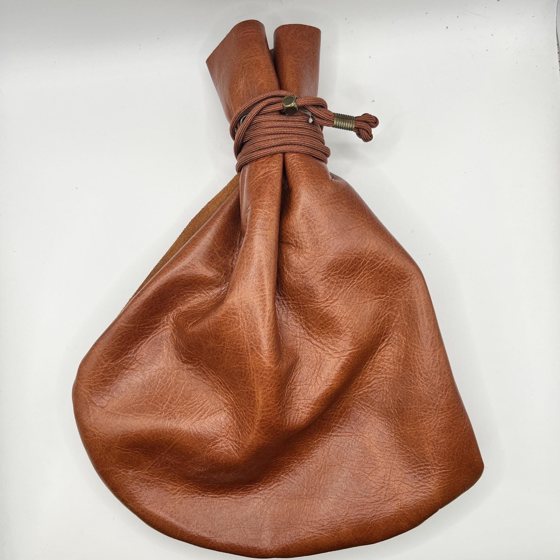 Handcrafted leather dice bag with drawstring, ideal for storing RPG dice sets. Perfect for DnD, tabletop games, or as a fantasy gift for gamers.