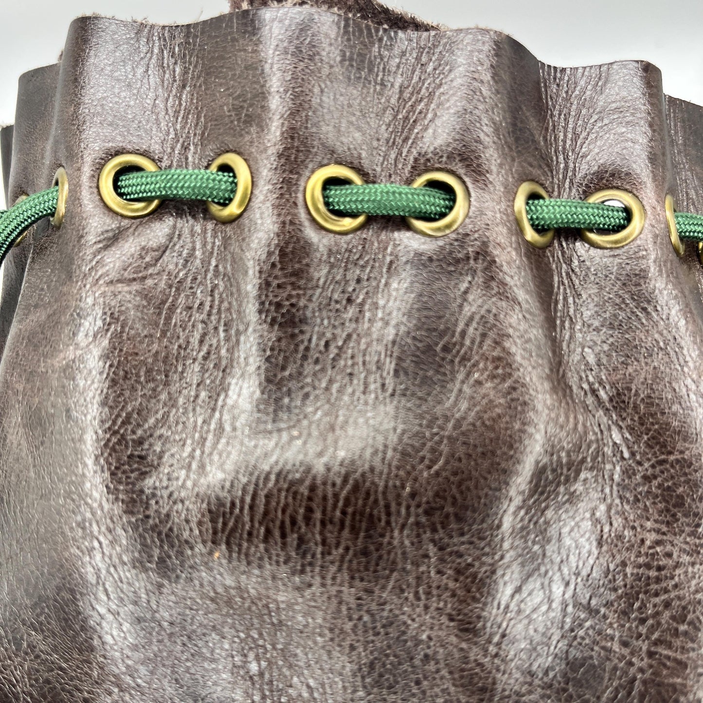 Handcrafted leather dice bag with drawstring, ideal for storing RPG dice sets. Perfect for DnD, tabletop games, or as a fantasy gift for gamers.