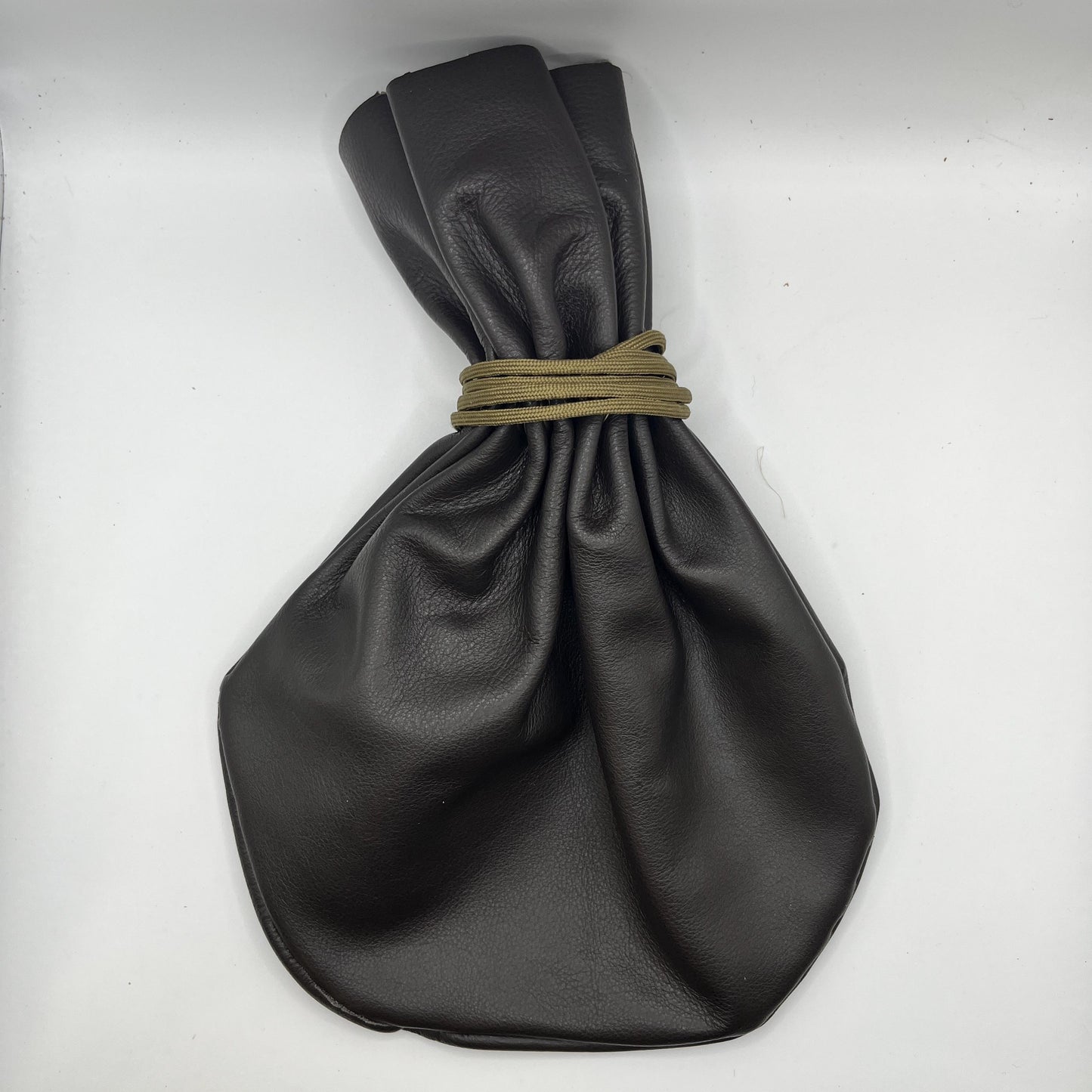Handcrafted leather dice bag with drawstring, ideal for storing RPG dice sets. Perfect for DnD, tabletop games, or as a fantasy gift for gamers.