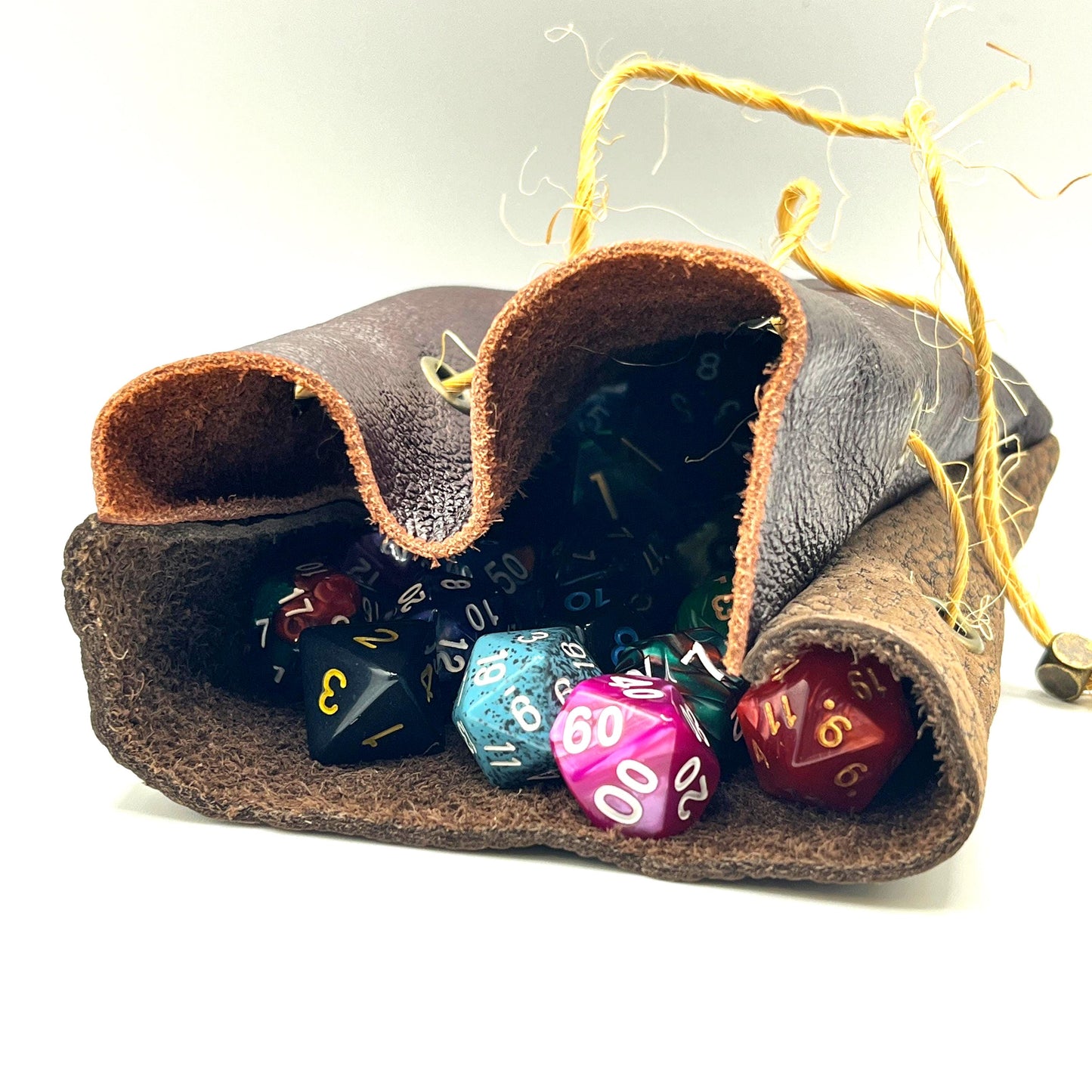 Handcrafted leather dice bag with drawstring, ideal for storing RPG dice sets. Perfect for DnD, tabletop games, or as a fantasy gift for gamers.