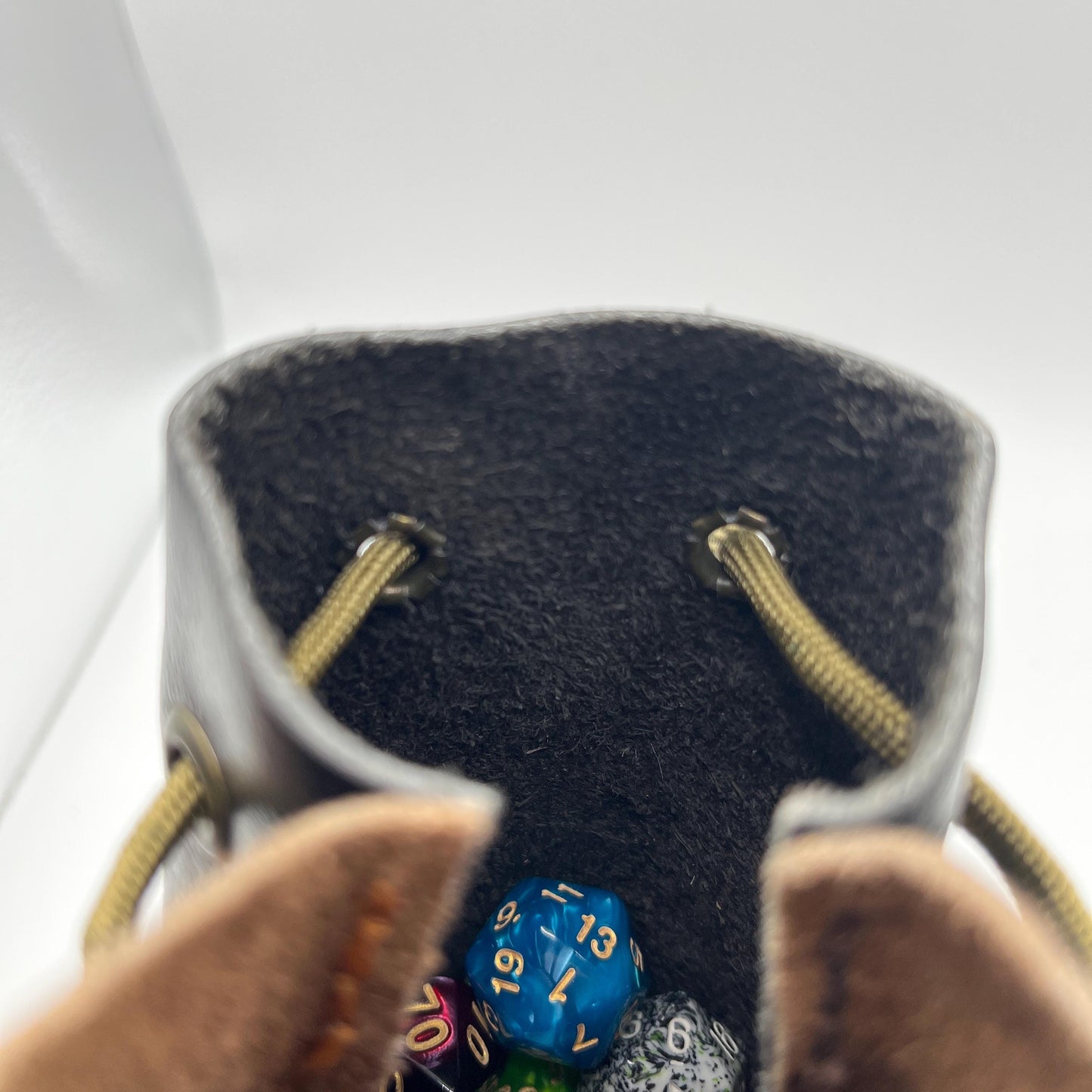 Handcrafted leather dice bag with drawstring, ideal for storing RPG dice sets. Perfect for DnD, tabletop games, or as a fantasy gift for gamers.