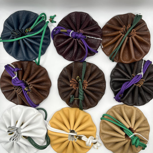 Handcrafted leather dice bag with drawstring, ideal for storing RPG dice sets. Perfect for DnD, tabletop games, or as a fantasy gift for gamers.