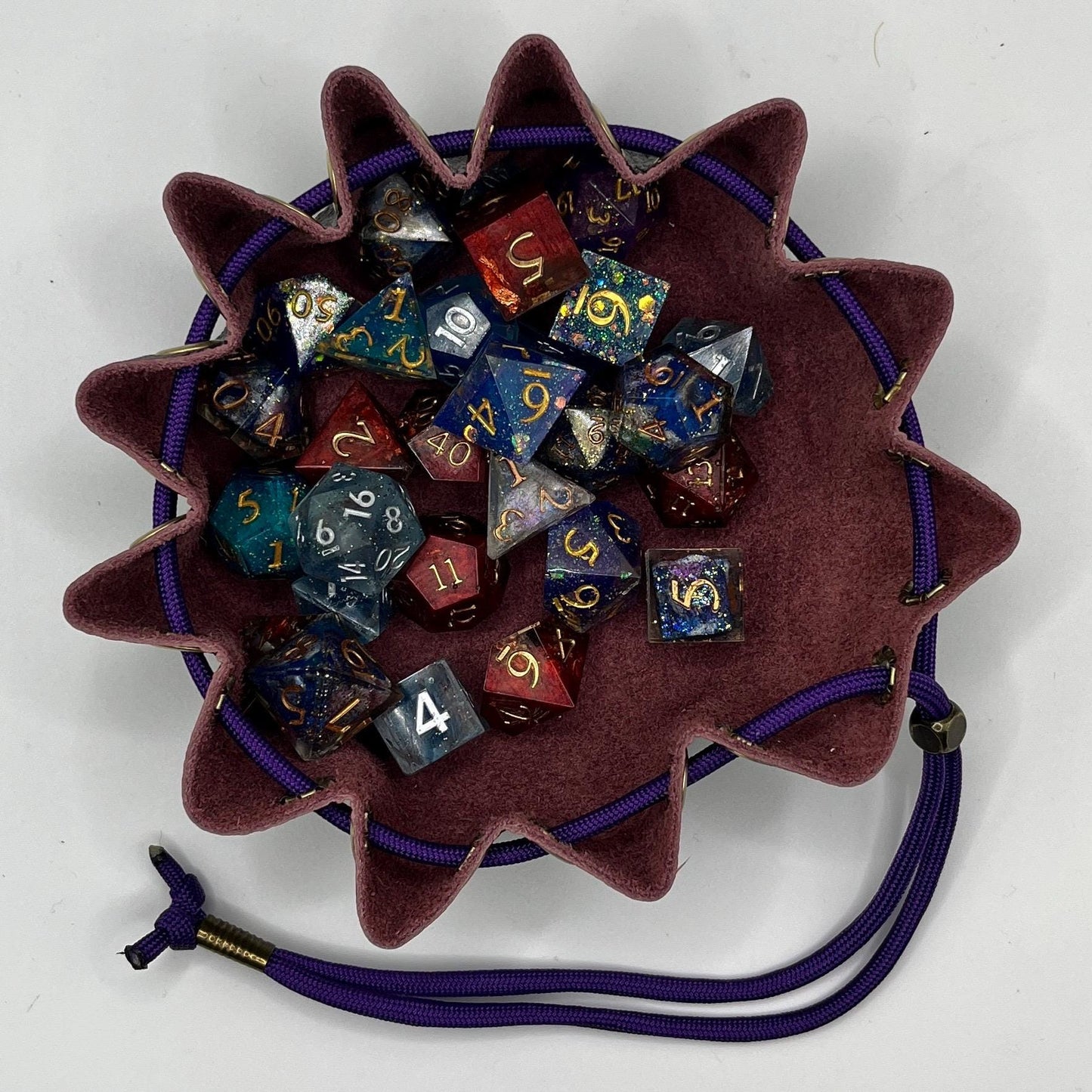 Handcrafted leather dice bag with drawstring, ideal for storing RPG dice sets. Perfect for DnD, tabletop games, or as a fantasy gift for gamers.