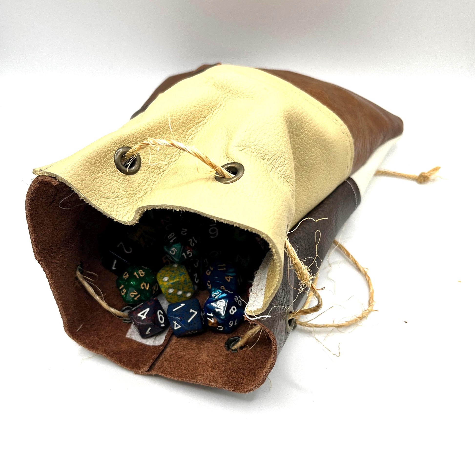 Handcrafted leather dice bag with drawstring, ideal for storing RPG dice sets. Perfect for DnD, tabletop games, or as a fantasy gift for gamers.