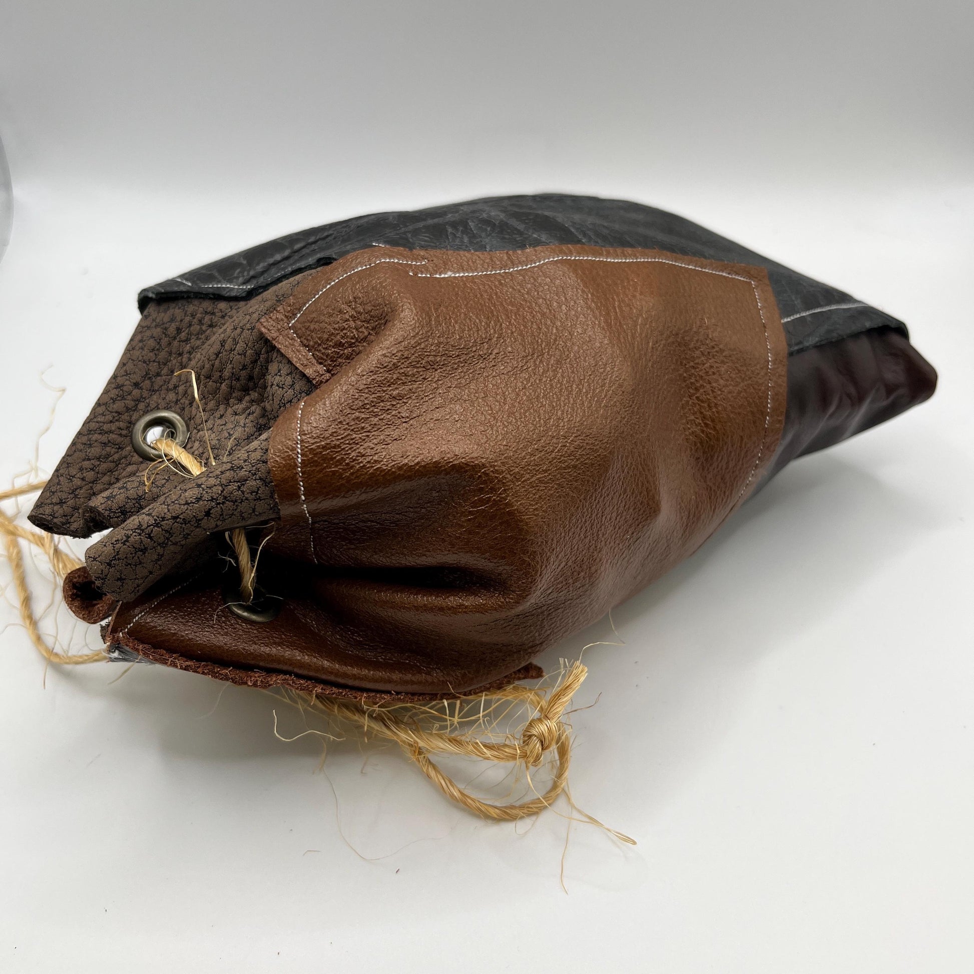 Handcrafted leather dice bag with drawstring, ideal for storing RPG dice sets. Perfect for DnD, tabletop games, or as a fantasy gift for gamers.