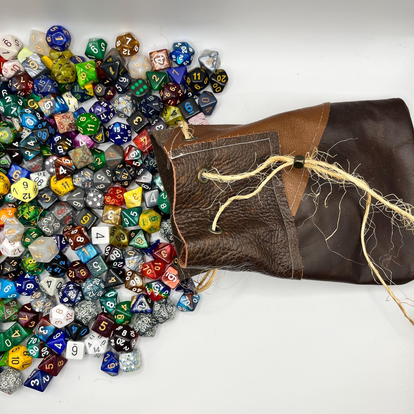 Handcrafted leather dice bag with drawstring, ideal for storing RPG dice sets. Perfect for DnD, tabletop games, or as a fantasy gift for gamers.