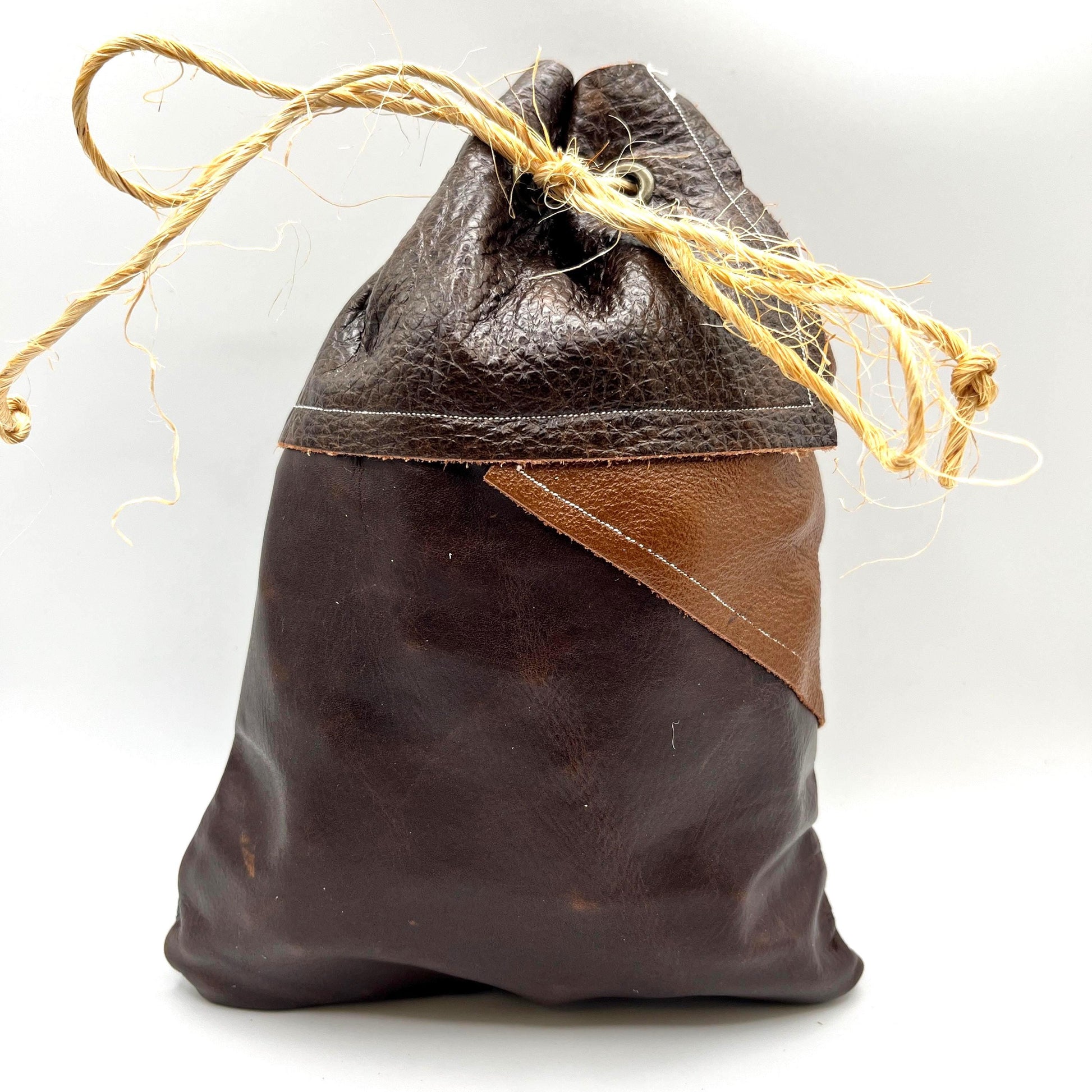 Handcrafted leather dice bag with drawstring, ideal for storing RPG dice sets. Perfect for DnD, tabletop games, or as a fantasy gift for gamers.
