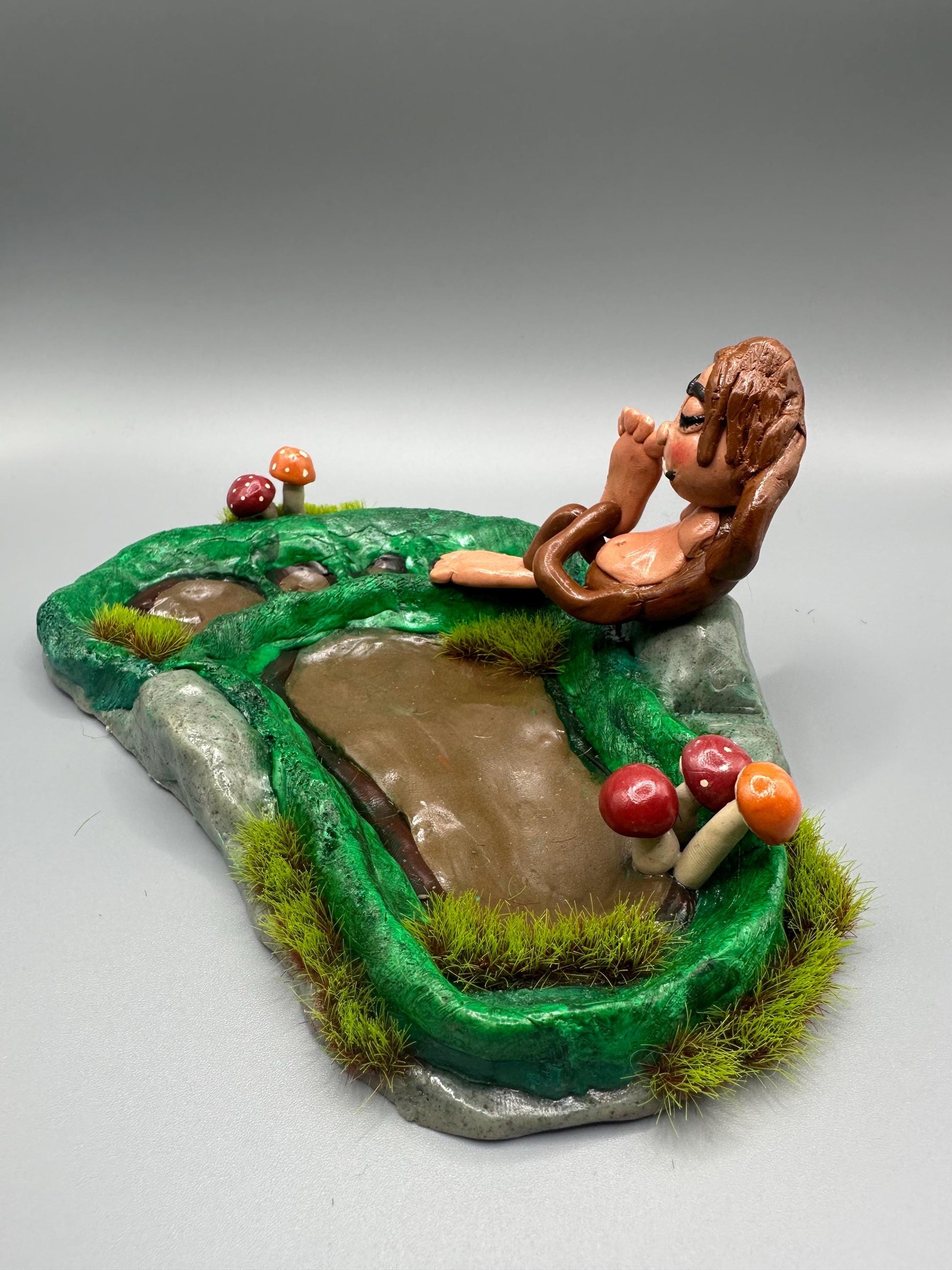 Cute handmade polymer clay dice tray and holder for a cryptid lover with a baby Bigfoot theme. Perfect gift for RPG, D&D, cryptid lovers and fantasy lovers.