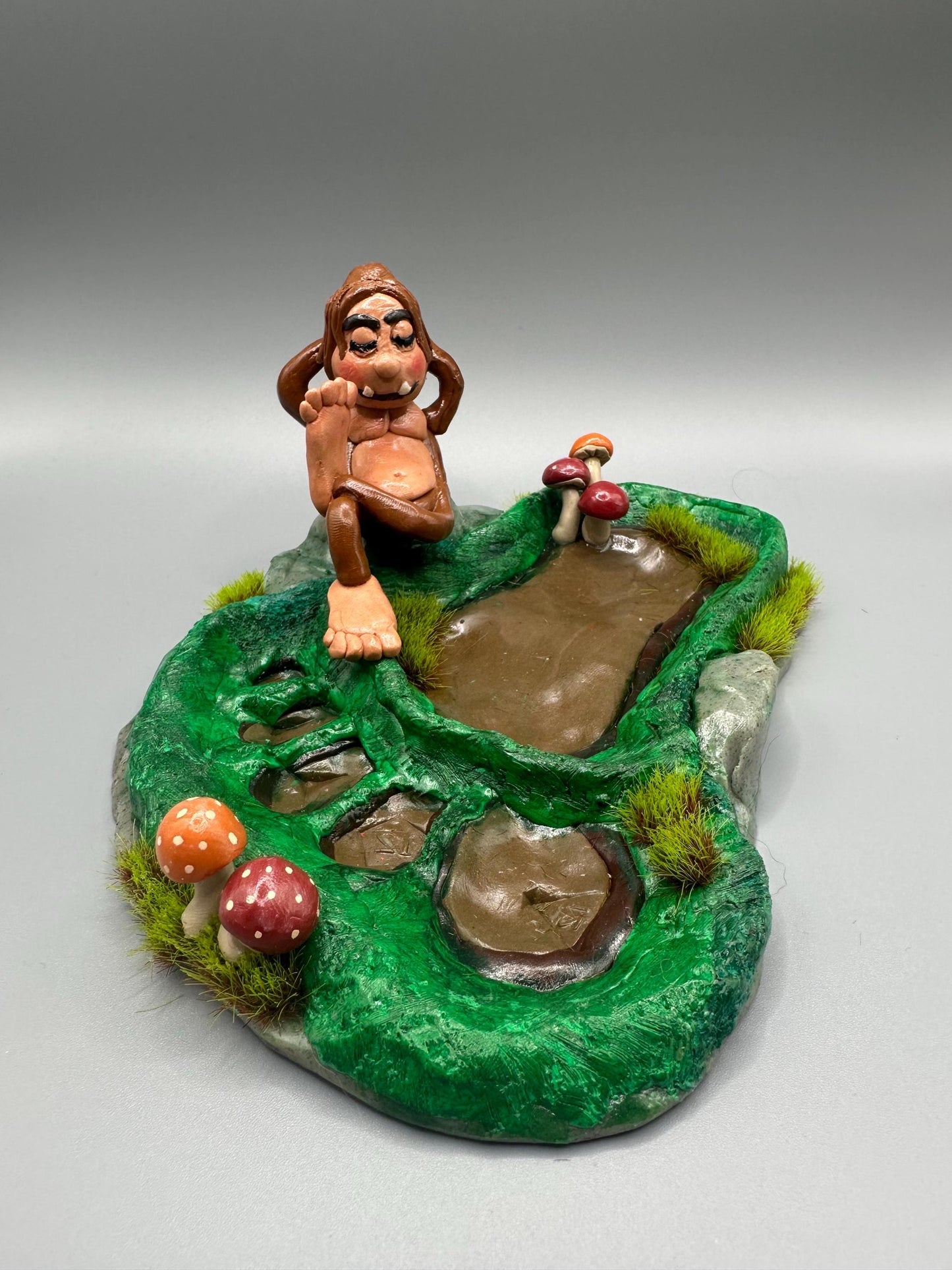 Cute handmade polymer clay dice tray and holder for a cryptid lover with a baby Bigfoot theme. Perfect gift for RPG, D&D, cryptid lovers and fantasy lovers.