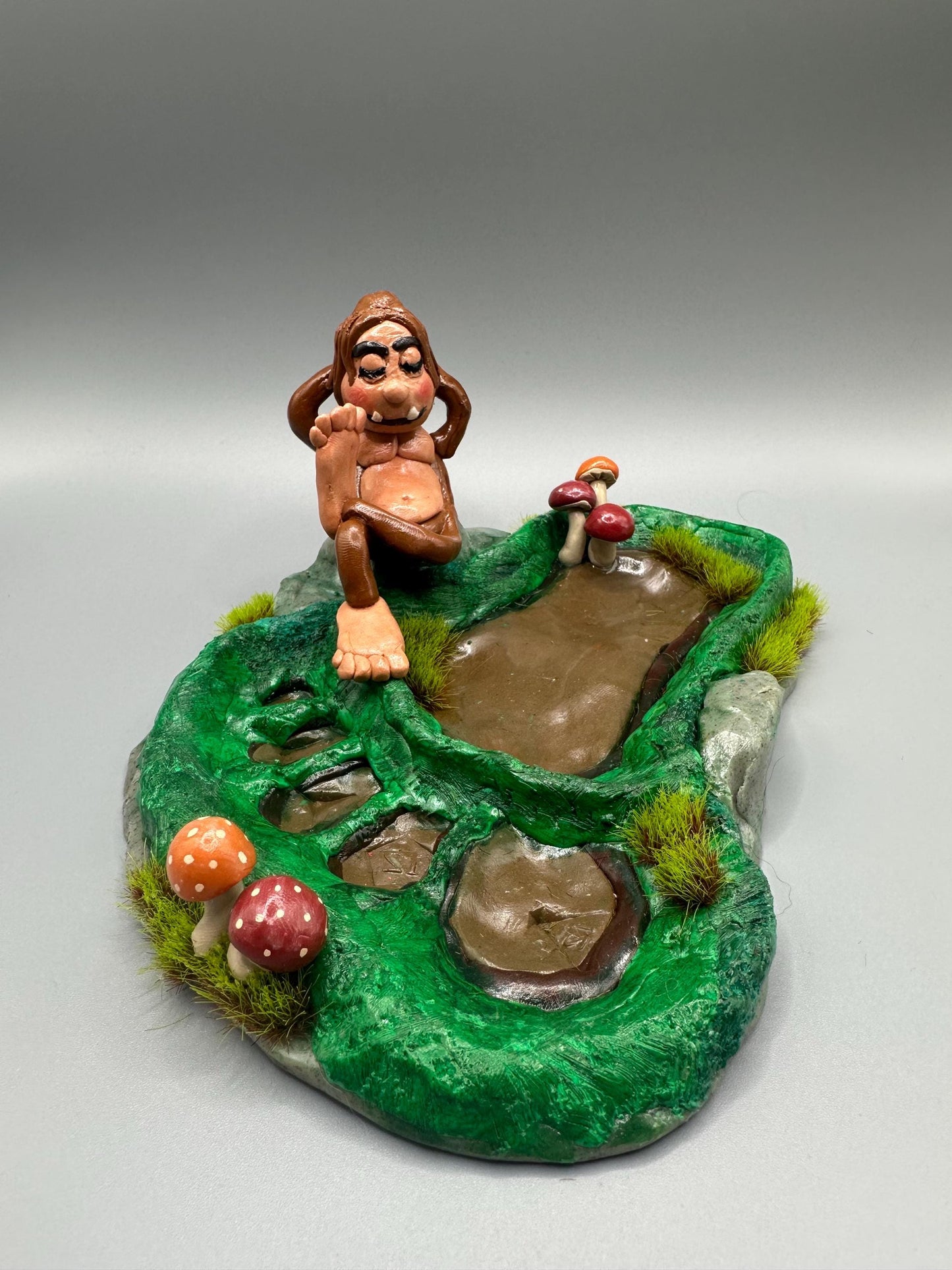 Cute handmade polymer clay dice tray and holder for a cryptid lover with a baby Bigfoot theme. Perfect gift for RPG, D&D, cryptid lovers and fantasy lovers.