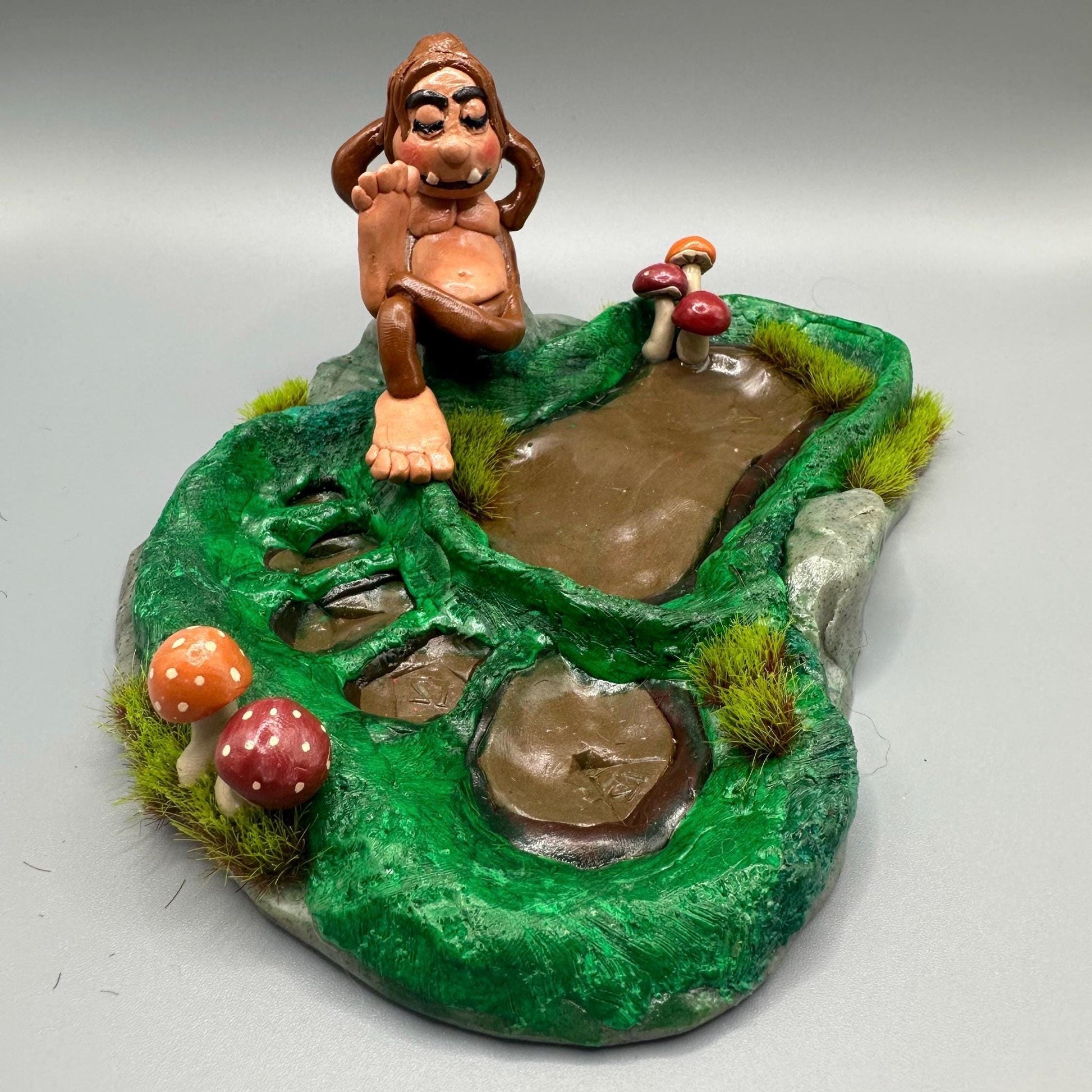 Cute handmade polymer clay dice tray and holder for a cryptid lover with a baby Bigfoot theme. Perfect gift for RPG, D&D, cryptid lovers and fantasy lovers.