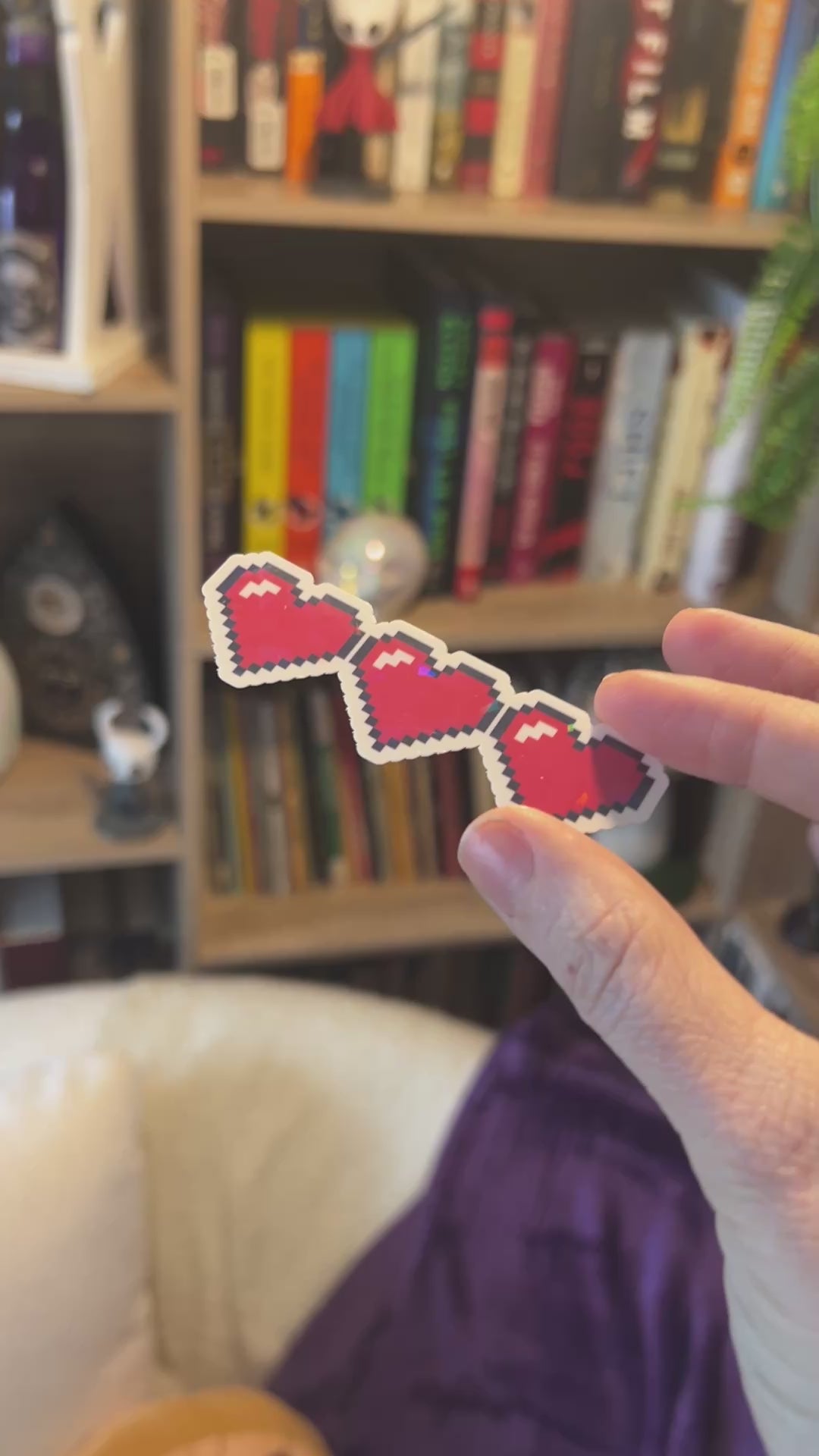 Holographic gamer heart sticker featuring 3 red pixel hearts in a heart container design. Perfect for laptops, water bottles, and game-themed journals.