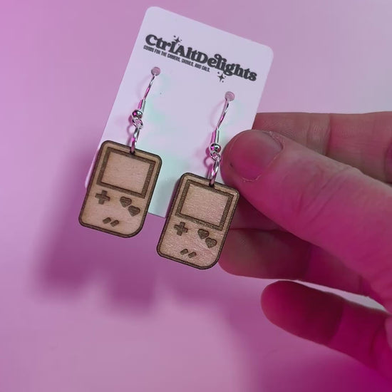 Wooden laser engraved Gameboy earrings with heart-shaped buttons. Lightweight dangle earrings for gamers and retro game lovers. Geeky gift for gamer girls.