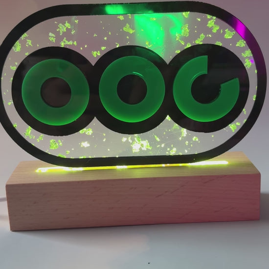 Handmade stamina wheel LED lamp with a hand-poured resin panel, silver leaf accents, laser-cut green acrylic design, and customizable RGB lighting.