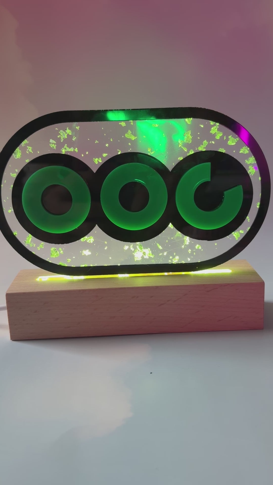 Handmade stamina wheel LED lamp with a hand-poured resin panel, silver leaf accents, laser-cut green acrylic design, and customizable RGB lighting.