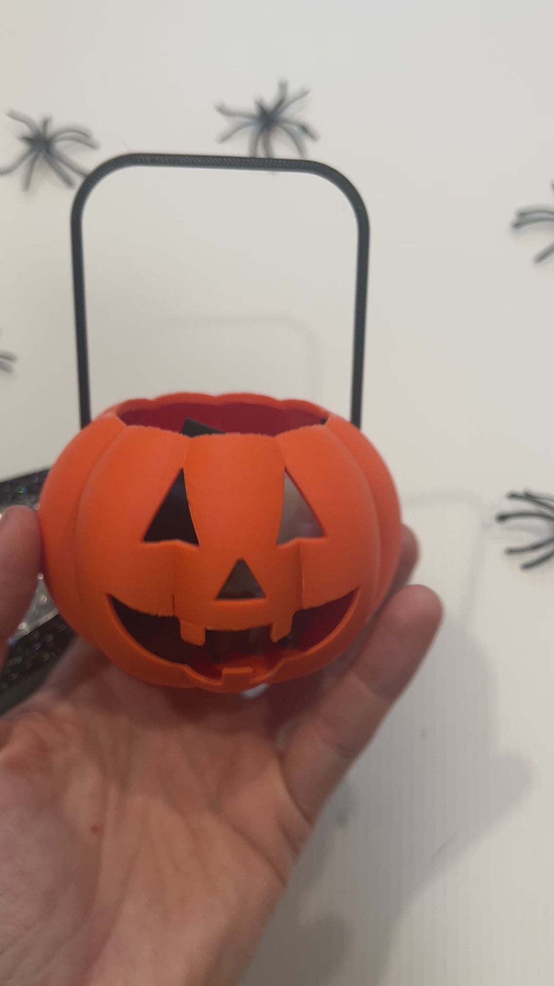 Cute Halloween clicker set with glow-in-the-dark ghost, candy corn, chocolate bat, and wrapped candy fidget toys in a festive pumpkin pail container.