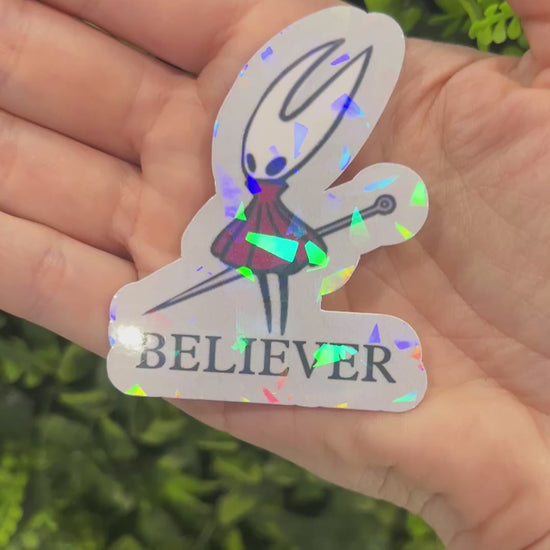 Holographic Hornet “BELIEVER” vinyl sticker inspired by Hollow Knight Silksong. Durable, shiny gamer decal perfect for laptops, water bottles, or journals.