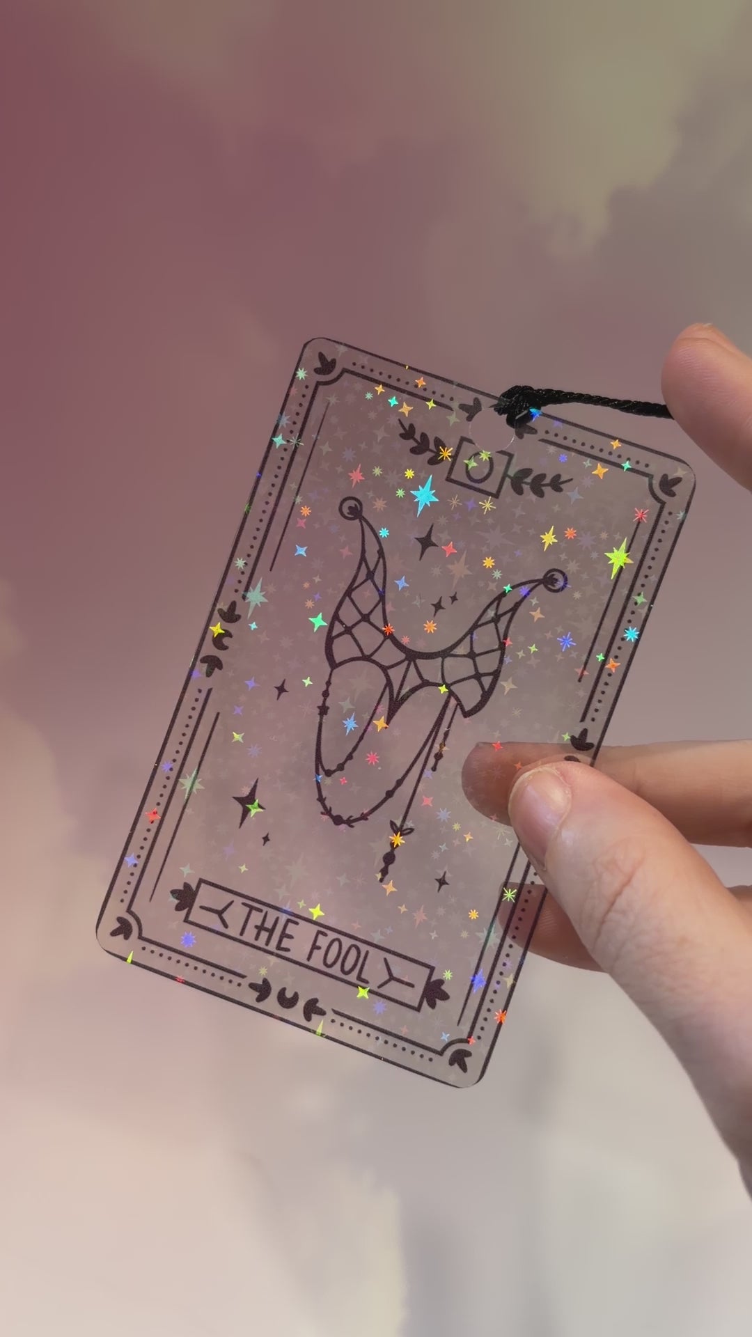 Clear holographic tarot card bookmark with elegant black line art on transparent waterproof cardstock. Finished with a black tassel and shimmering holographic pattern that changes in the light. Available in all 22 Major Arcana designs.