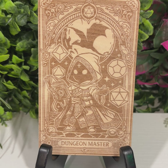 Laser engraved 3mm basswood tarot cards featuring a Dungeon Master class design from Dungeons and Dragons. Intricate fantasy artwork with dice, magic symbols, and ornate gothic detailing.