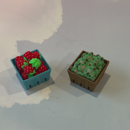 Farmers market themed fidget clicker featuring strawberries and frogs.
