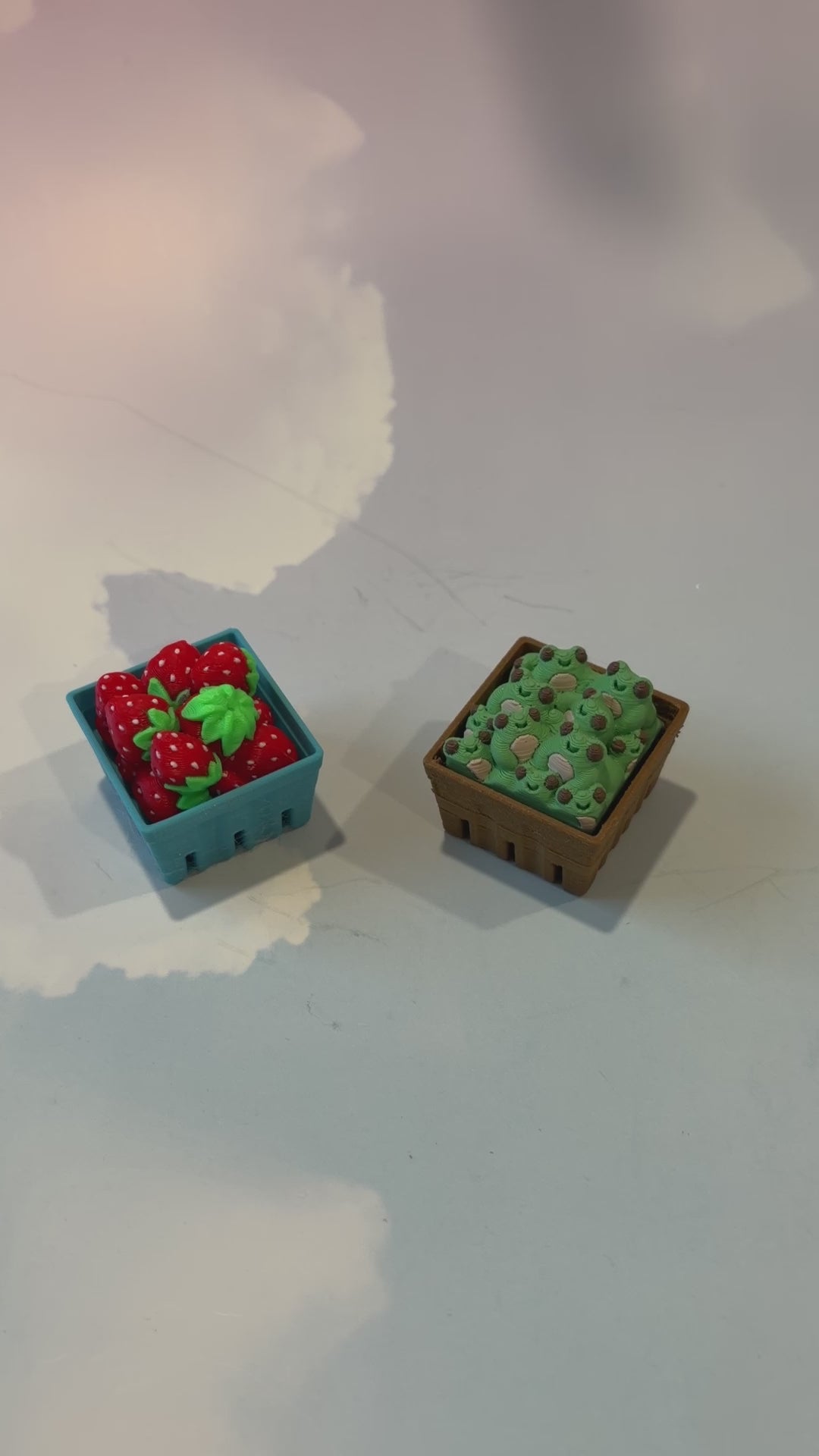 Farmers market themed fidget clicker featuring strawberries and frogs.