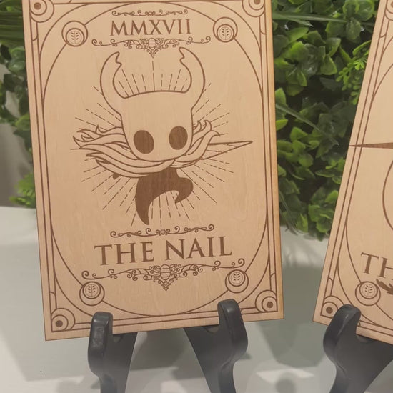 Set of two laser engraved wood tarot cards featuring Hollow Knight as The Nail and Hornet as the Needle. Unique indie game fan art collectible.