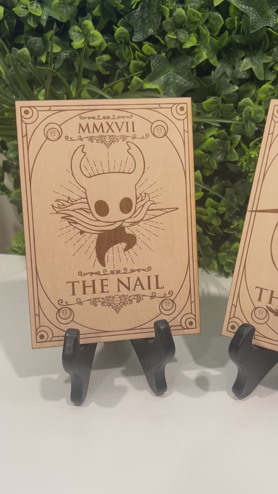 Set of two laser engraved wood tarot cards featuring Hollow Knight as The Nail and Hornet as the Needle. Unique indie game fan art collectible.