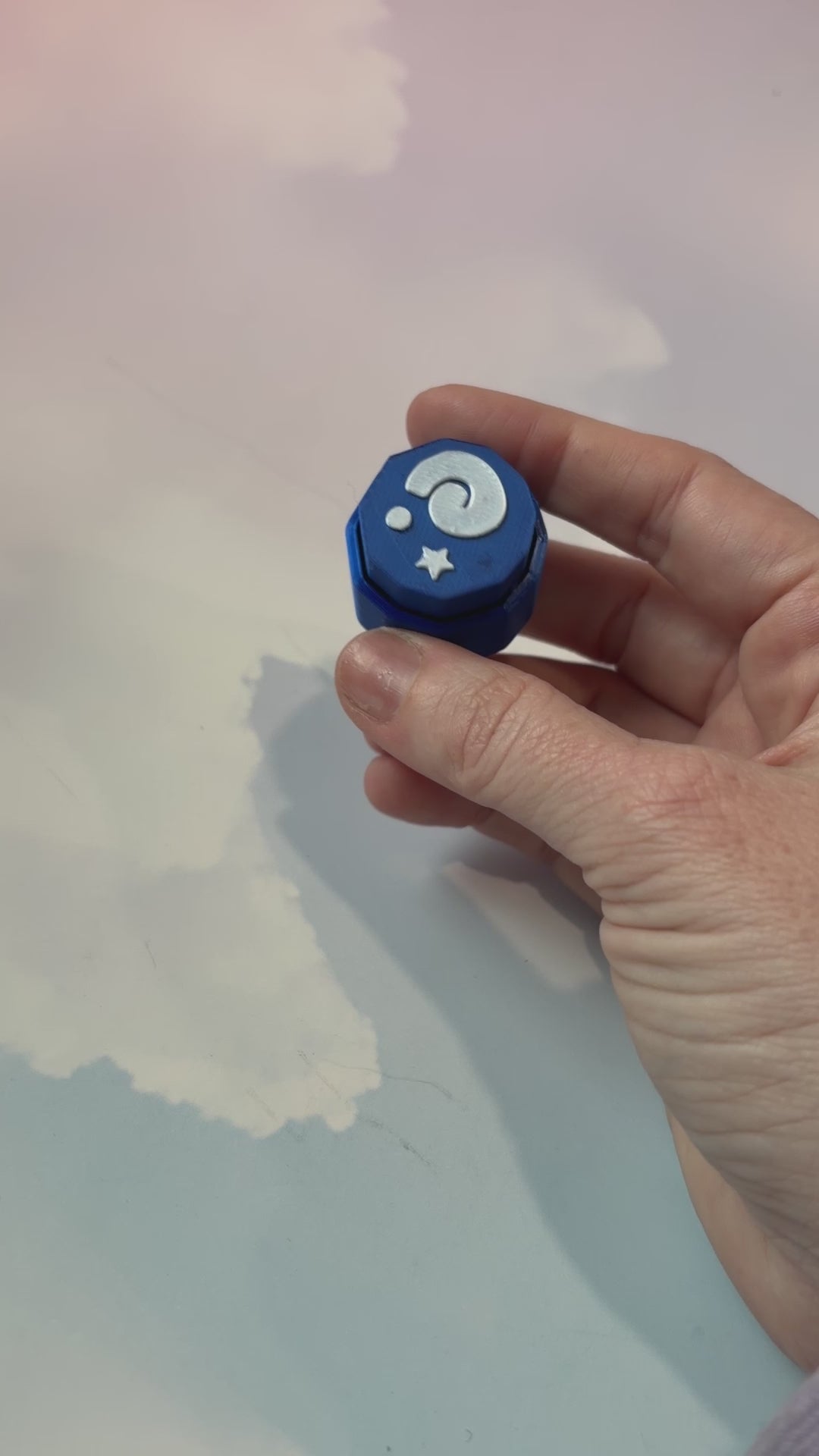 Blue animal crossing fossil themed fidget clicker with white design.
