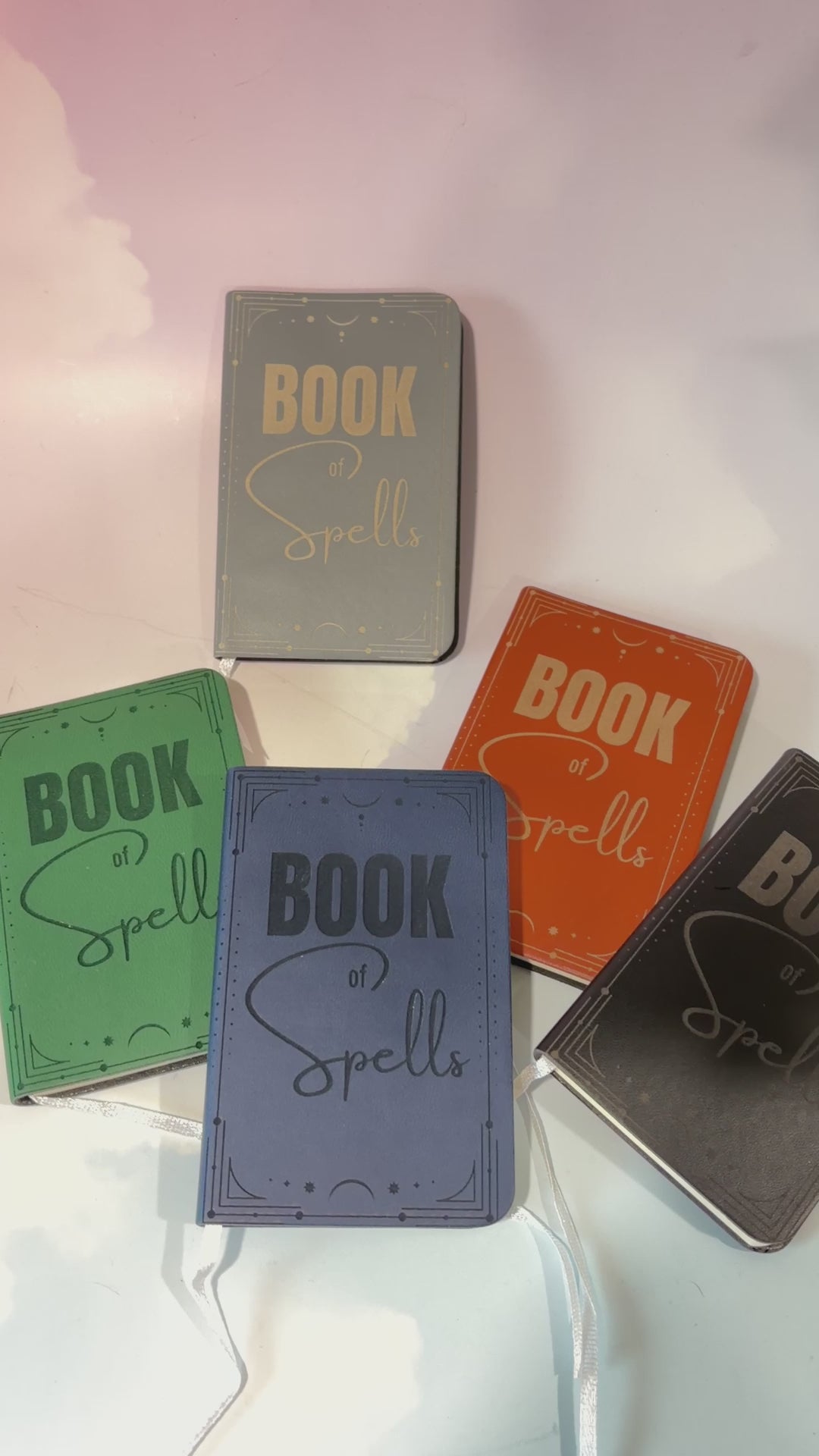 Mini green leather notebook with “Book of Spells” laser engraved on the cover in black lettering. Approximately 4 x 2.5 inches, with 50 lined pages. Available in brown, green, blue, gray, and black.
