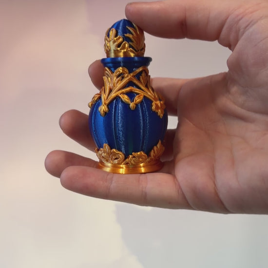 Royal blue and gold 3D printed potion bottle fidget clicker with ornate fantasy details, available in clicky or silent versions.