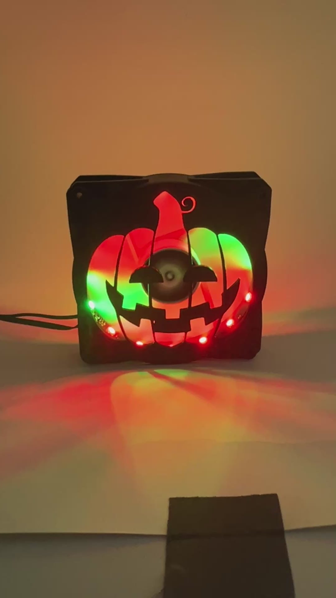 3D printed PC fan grill shaped like a spooky jack-o'-lantern pumpkin. Perfect Halloween-themed case mod for gamers and tech lovers.