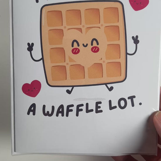 Funny kawaii greeting card with a smiling waffle and the pun "I love you a waffle lot." Perfect for anniversaries, Valentine's Day, or sweet love notes.
