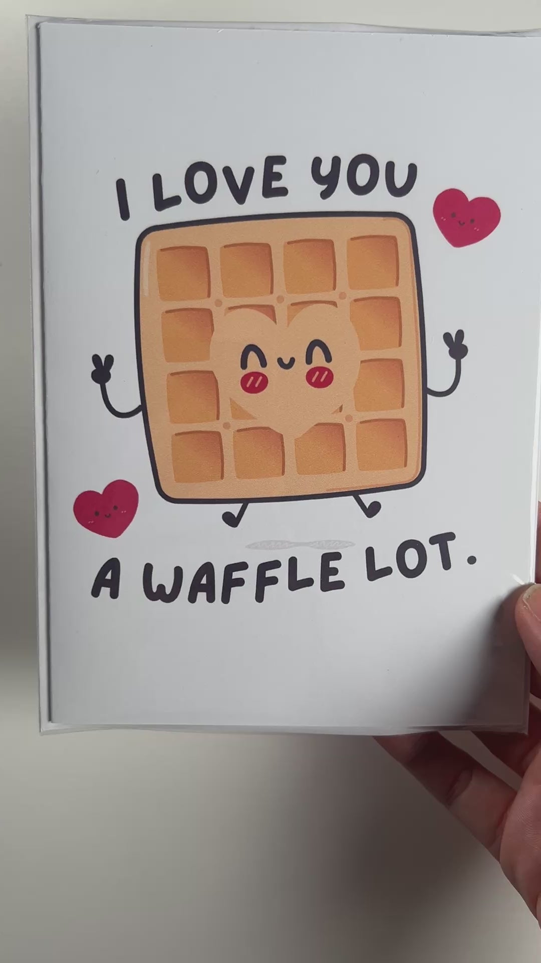 Funny kawaii greeting card with a smiling waffle and the pun "I love you a waffle lot." Perfect for anniversaries, Valentine's Day, or sweet love notes.