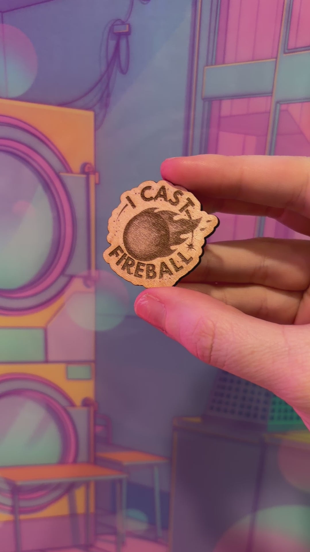 Laser engraved basswood pin reading "I Cast Fireball" for tabletop gamers.