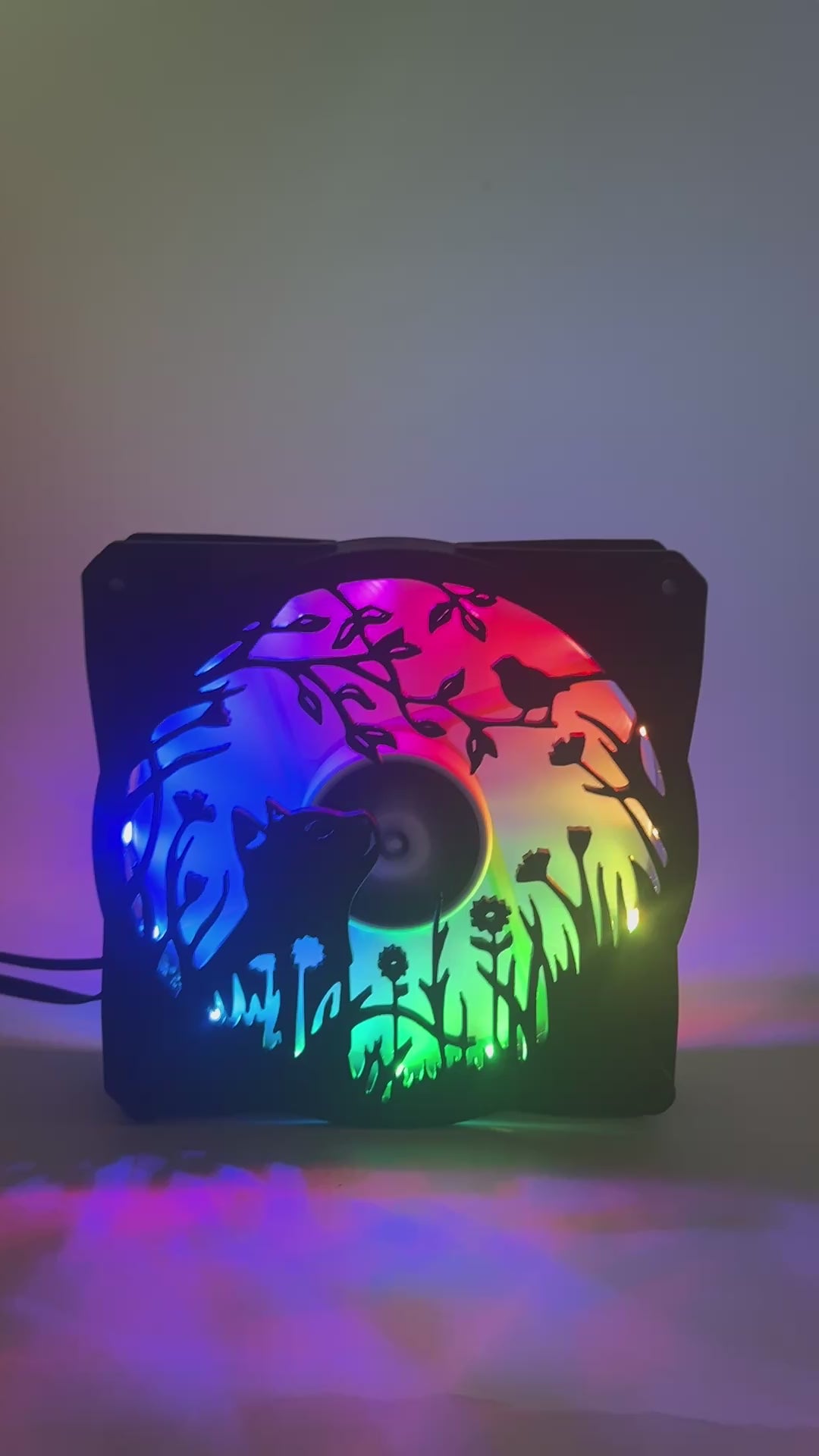 Adorable 3D printed PC fan grill featuring a cat and bird in a garden scene. Adds cozy charm and personality to any gaming or desktop setup.