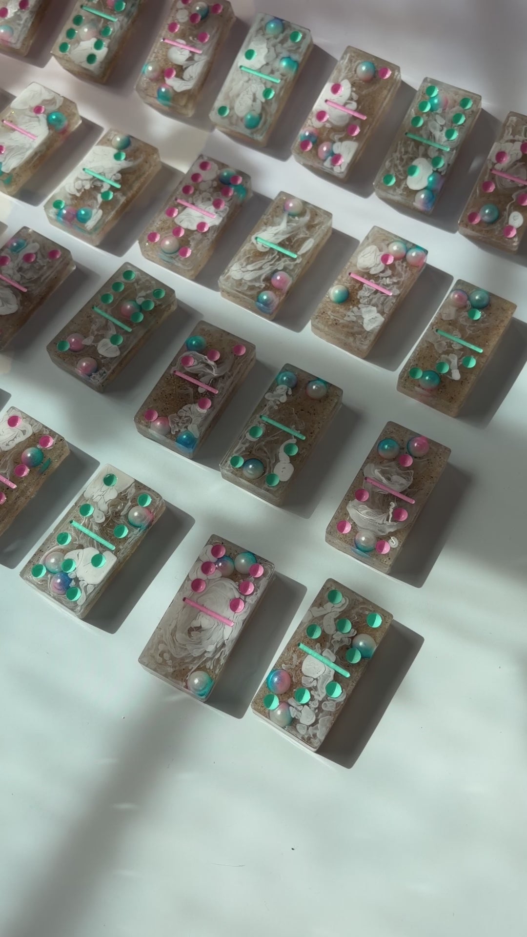Handmade seashore resin dominoes with pearls and sand.