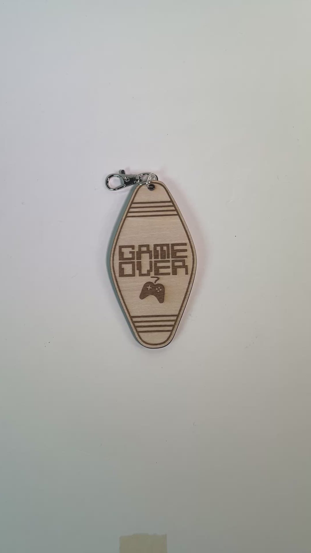 Laser engraved wood motel-style keychain featuring the phrase “Game Over” with a retro controller design. Perfect funny gift for gamers and nostalgia lovers.