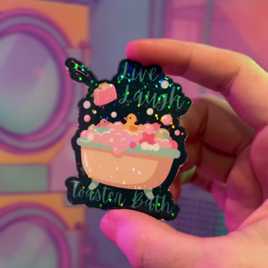 Holographic Live Laugh Toaster Bath vinyl sticker with bathtub, bubbles, rubber duck, and flying toaster.